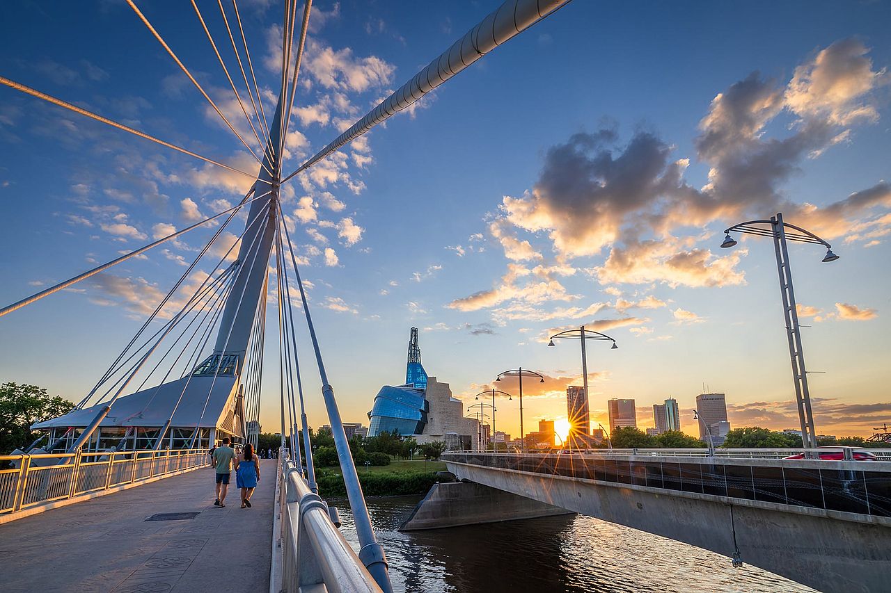 People walking along the Esplanade Riel footbridge.