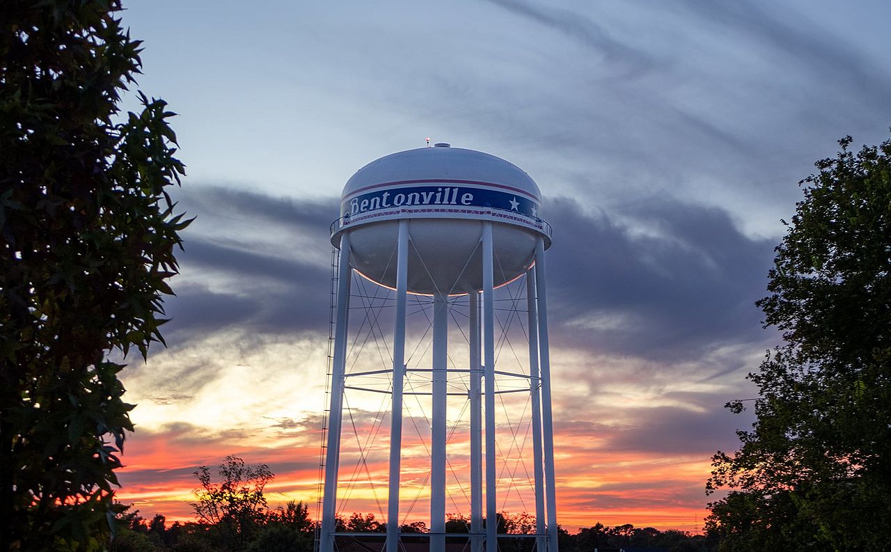 A view of the water tower in Bentonville during sunset.