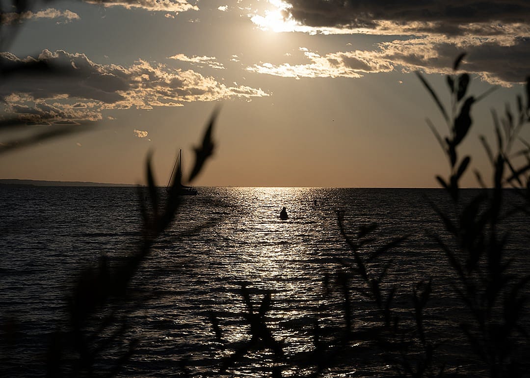 A person swims in Lake Ontario in St. Catherines, Canada.