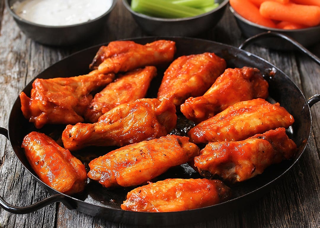 Homemade spicy Buffalo chicken wings served with blue cheese dip.