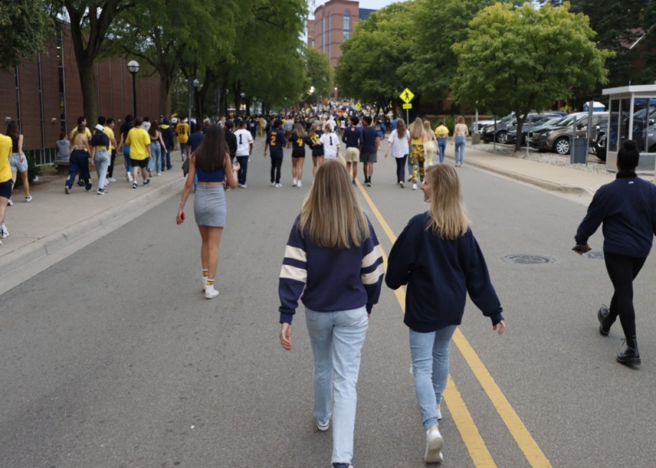 #24. University of Michigan - Ann Arbor Students walking to a game.