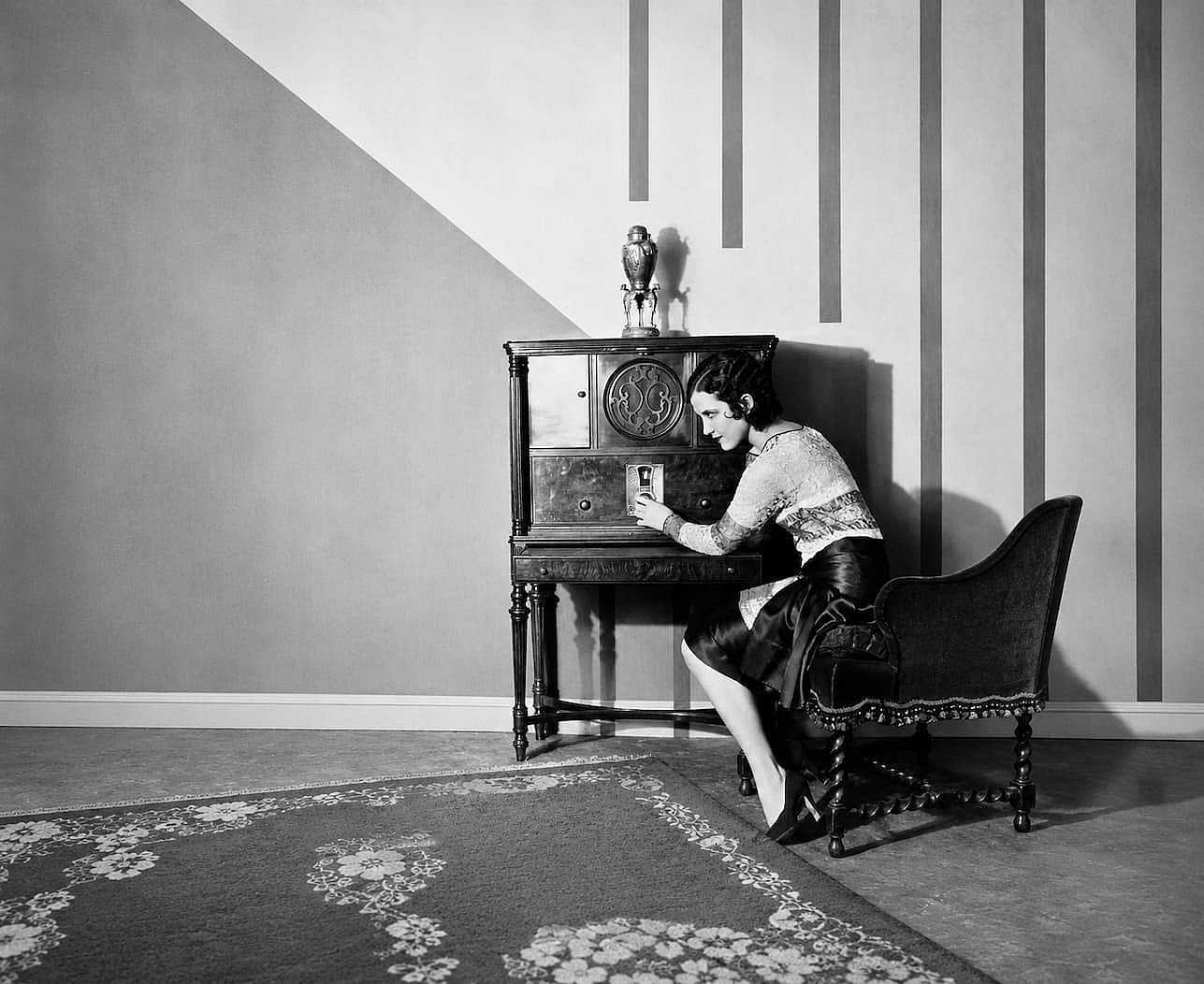 Tunning in by moving the dial of the radio.