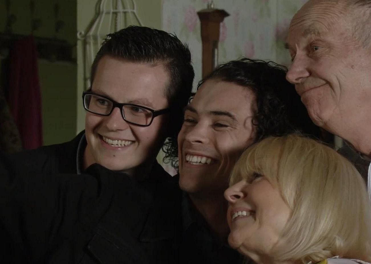 The cast poses for a photo.