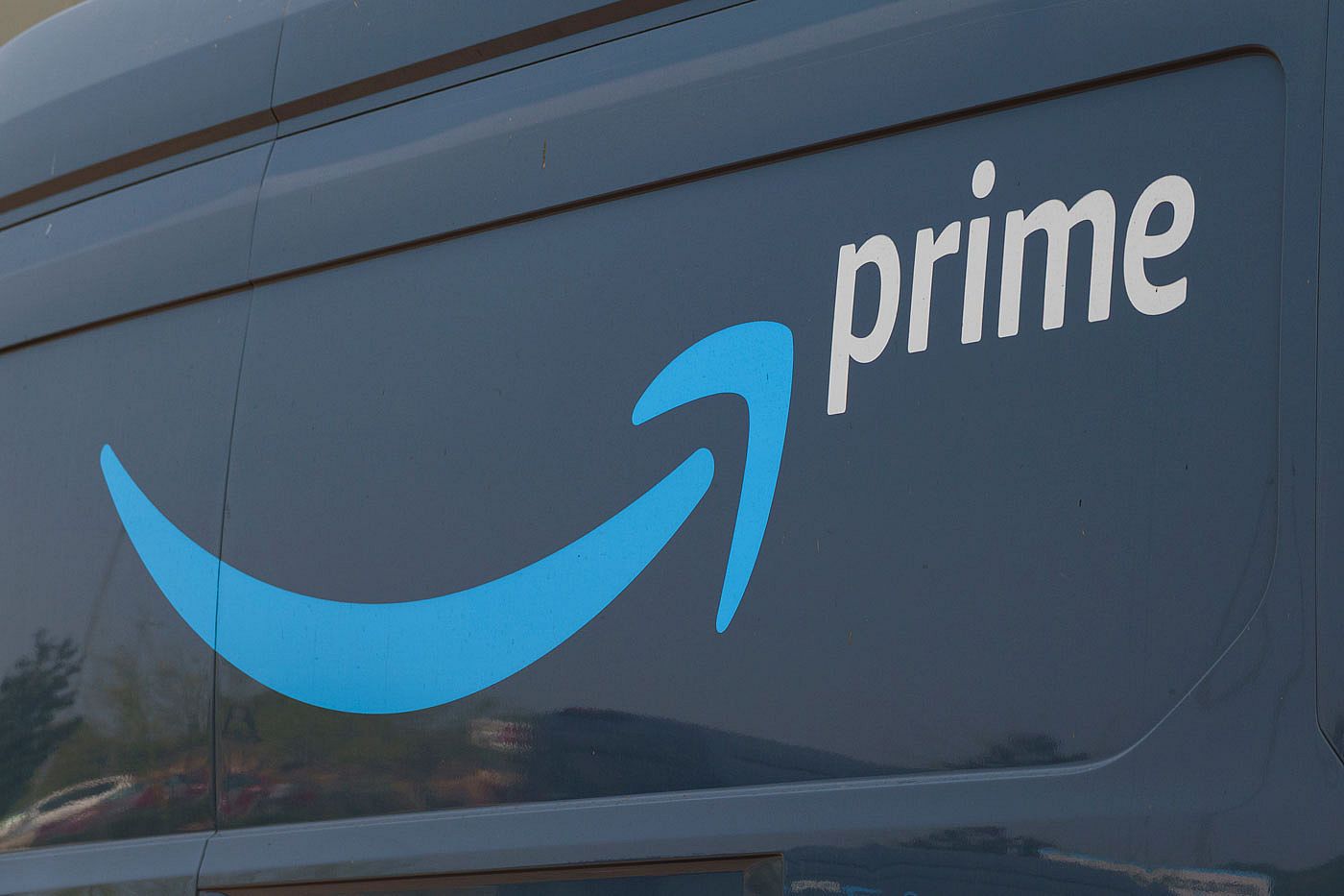 The Amazon prime logo on the side of a delivery vehicle.
