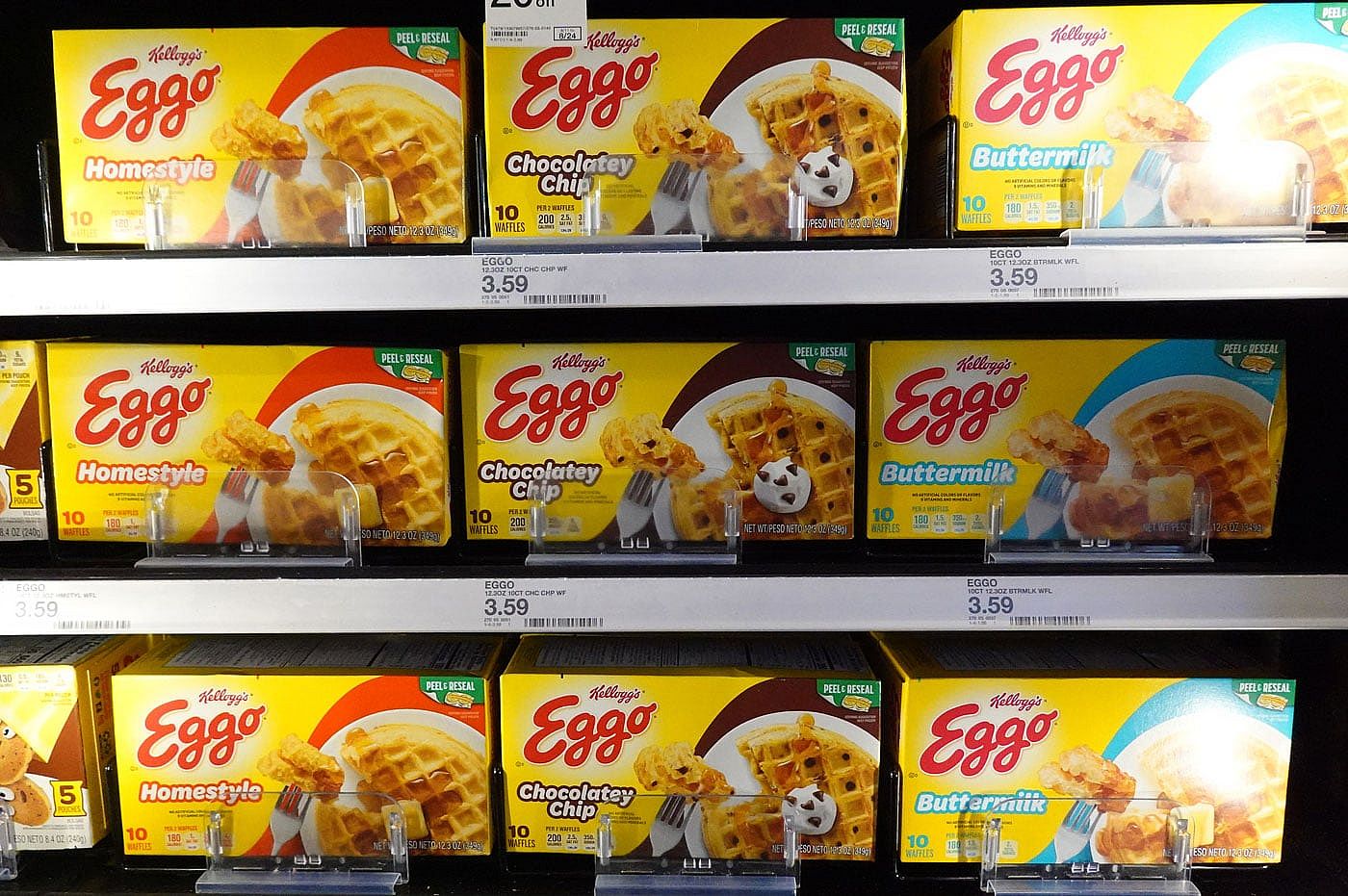 Boxes of Eggo Waffles in the freezer section of a grocery store.