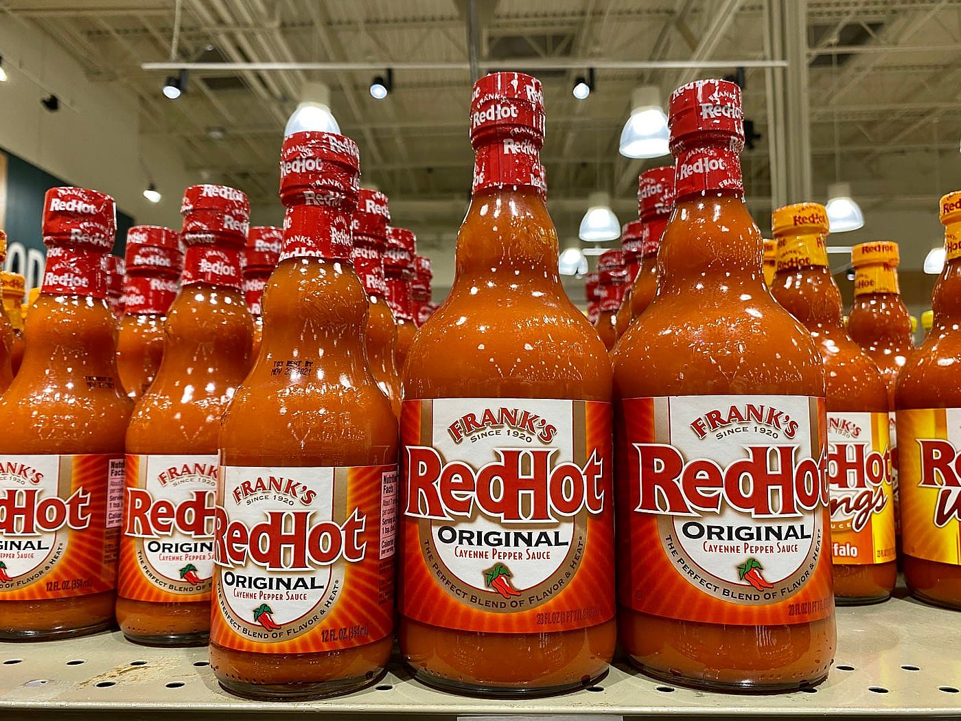 Several bottles of Frank's RedHot hot sauce at a local grocery store.
