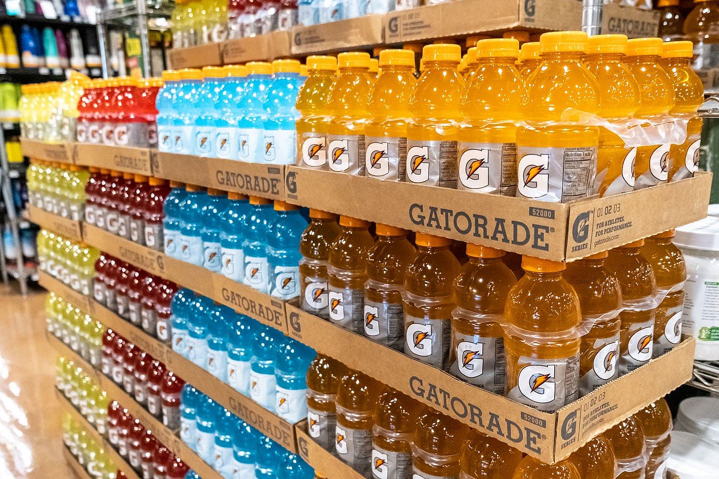 Cases of various Gatorade bottles stacked at a grocery store