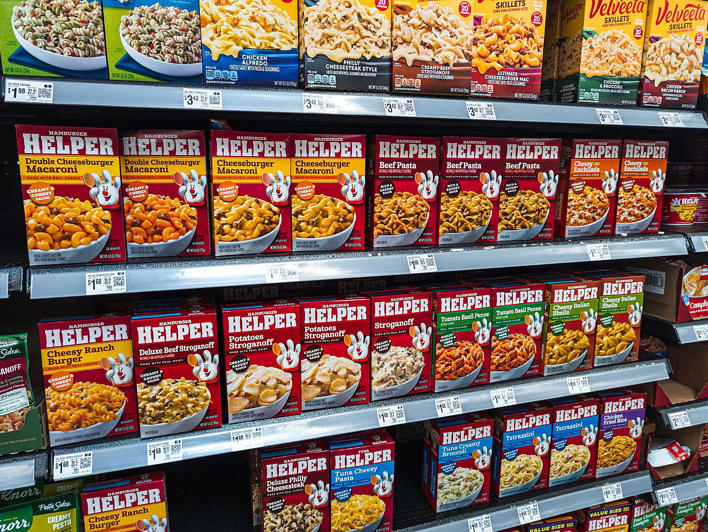 Boxes of various flavors of Hamburger Helper on a grocery store shelf