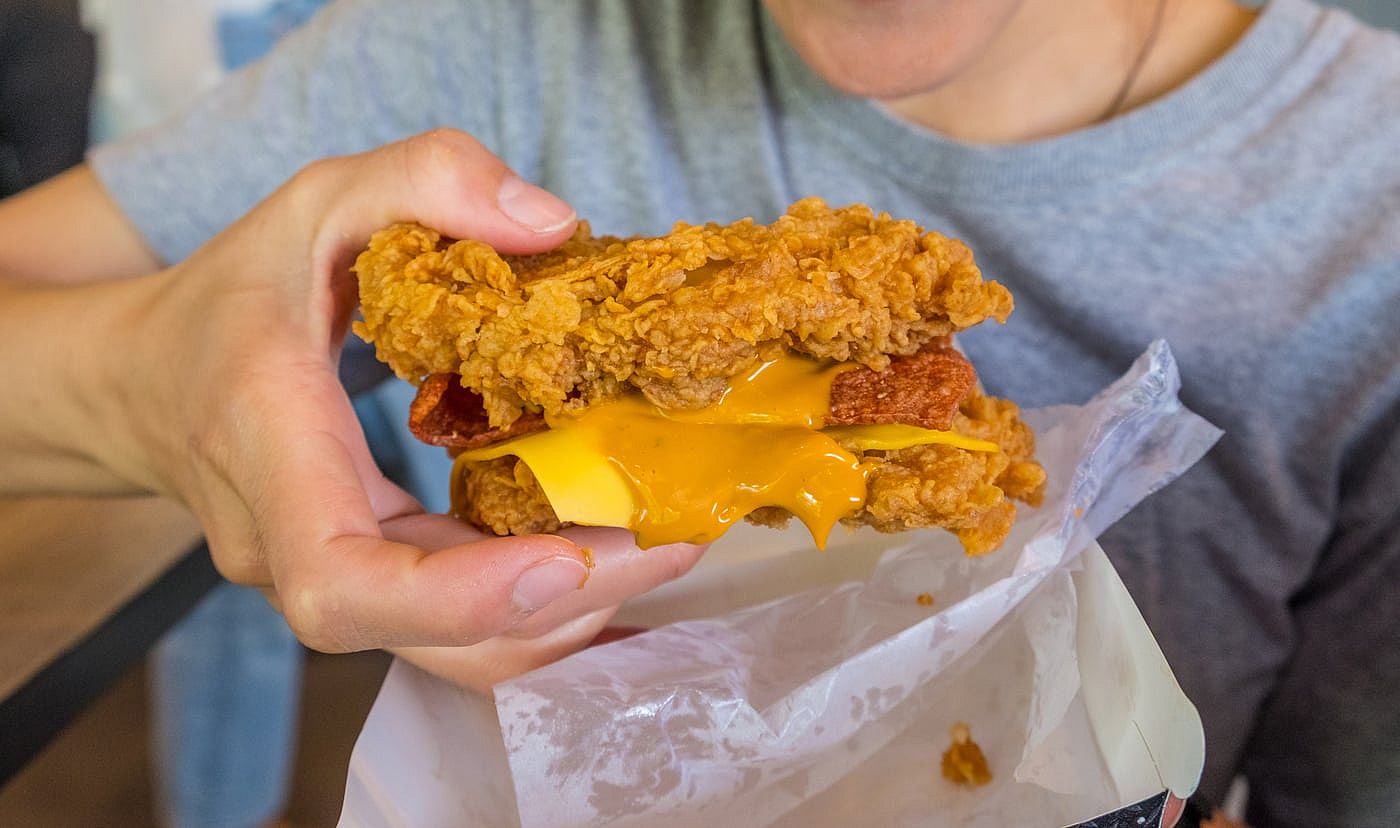 A woman holding a KFC Double Down