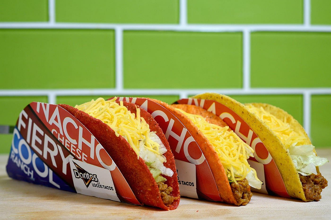 Three flavors of Taco Bell Doritos Locos tacos: Nacho cheese, Fiery, Cool Ranch