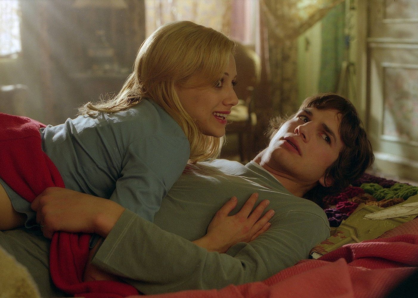 Brittany Murphy lying on top of Ashton Kutcher.