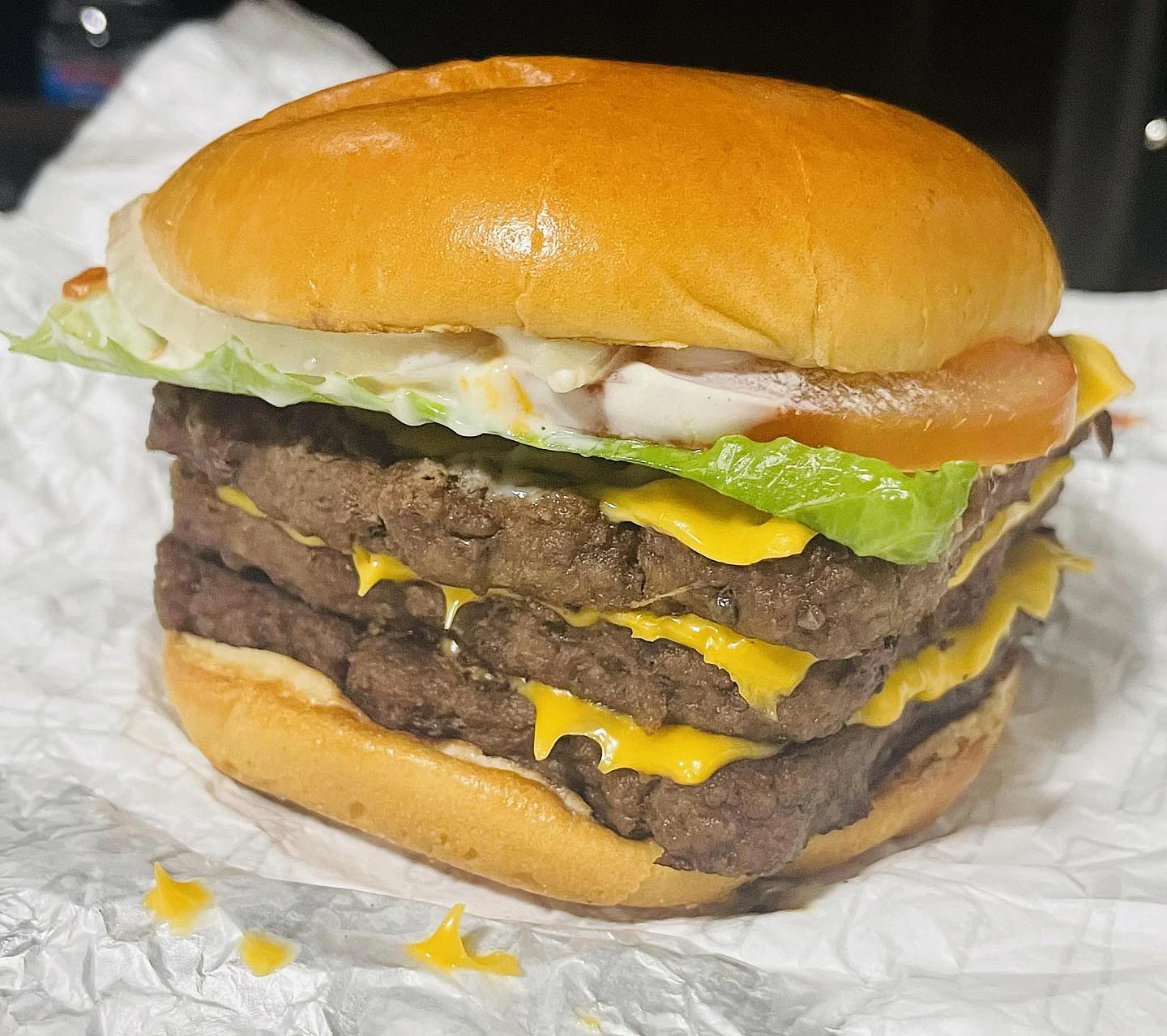 Photo of a Dave's Triple burger from Wendy's sitting on a wrapper