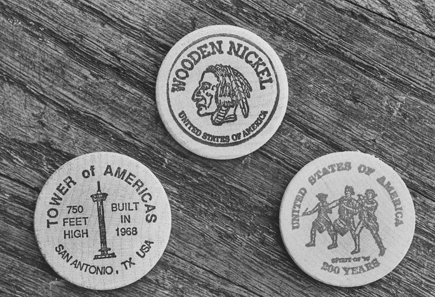 Closeup of 3 maple-cured wooden nickels showing off flip sides