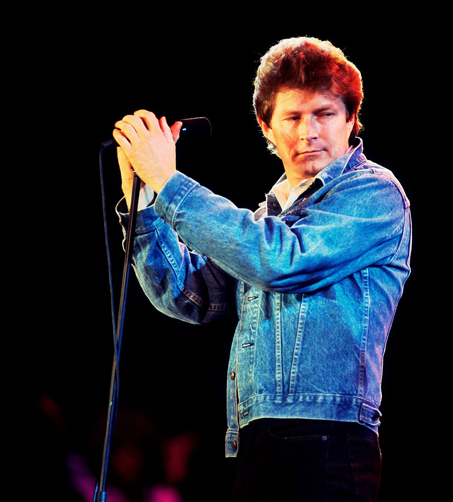 Don Henley in a jean jacket on stage performing at Veteran's Stadium for the first Farm Aid Concert in Champaign, Illinois,September 22, 1985.