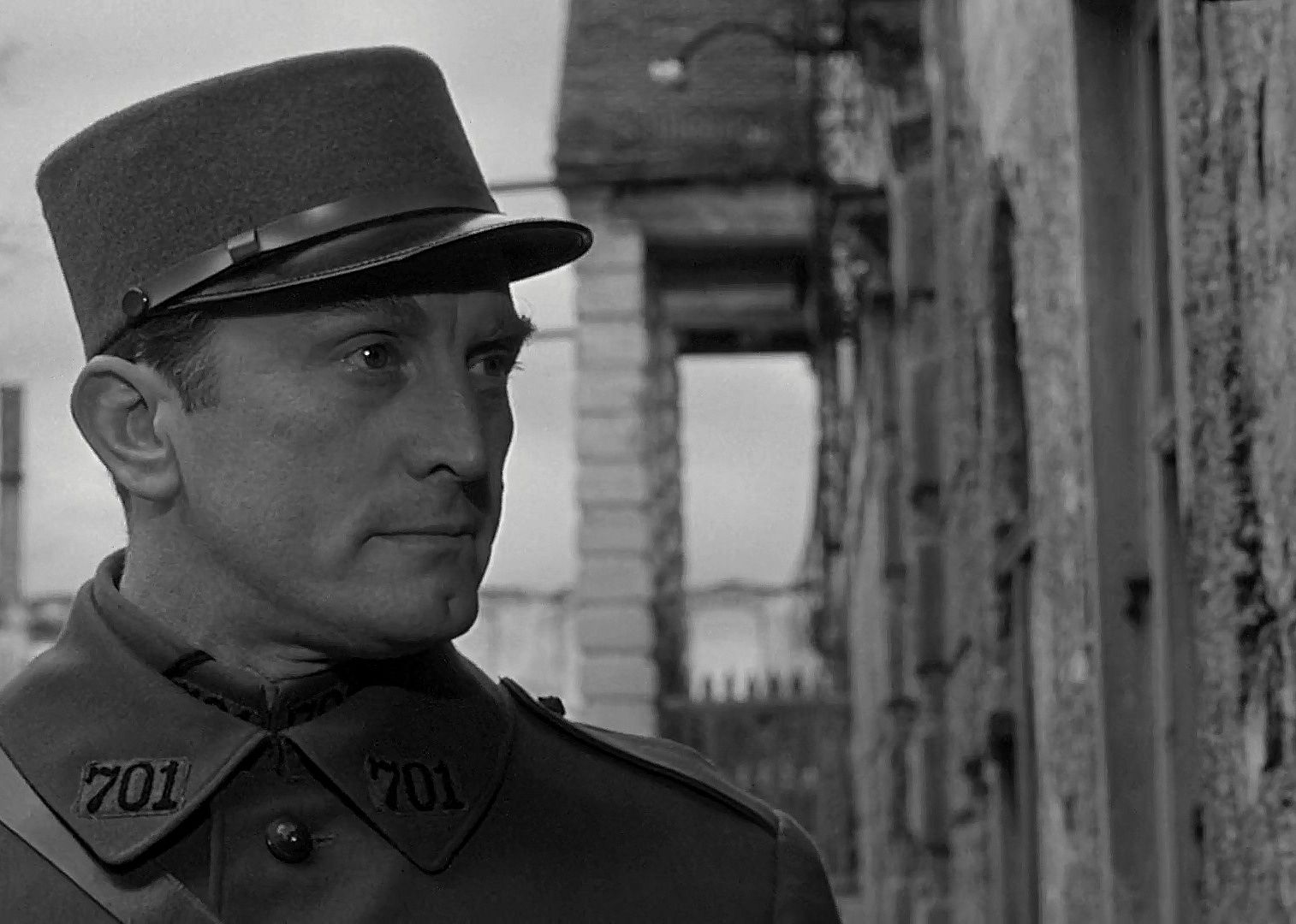 Kirk Douglas in a military uniform and hat.