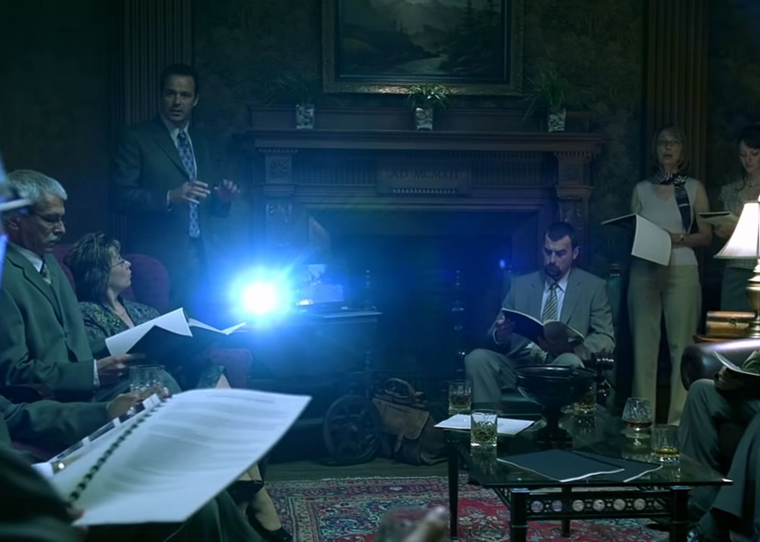 People dressed in business clothes in a dark room.