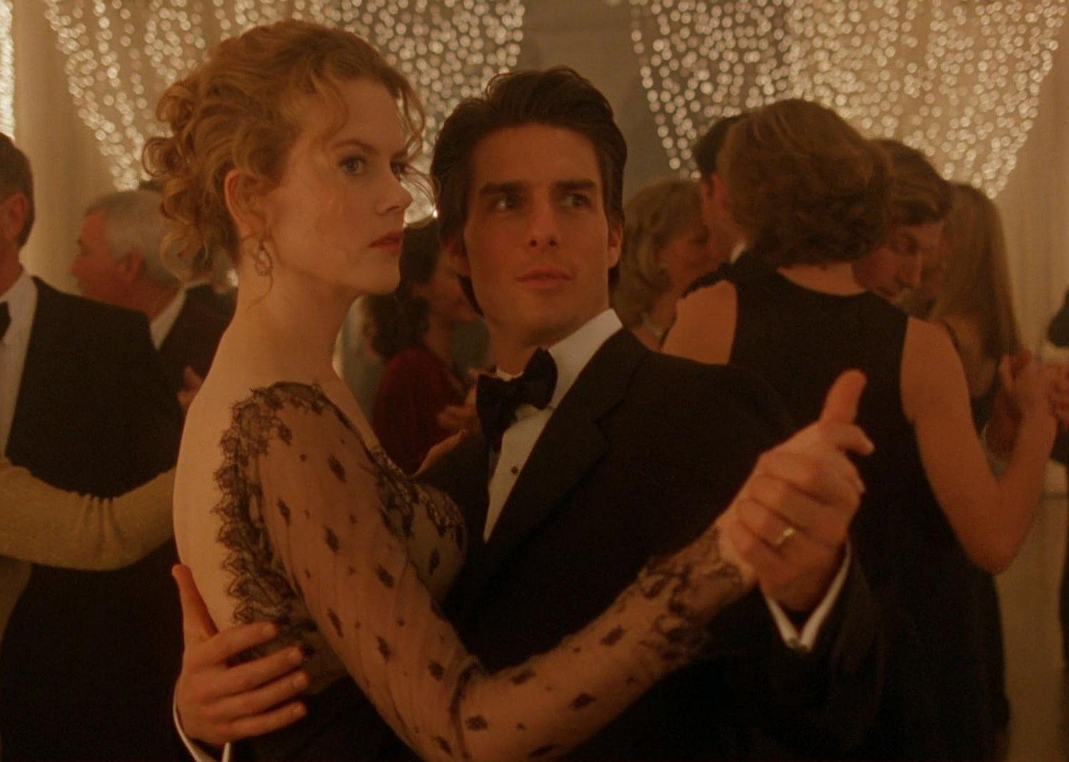 Nicole Kidman and Tom Cruise dancing in a ballroom.
