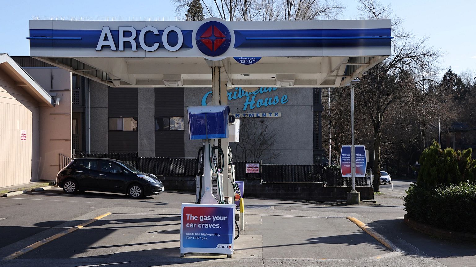 A car is parked at a gas station.