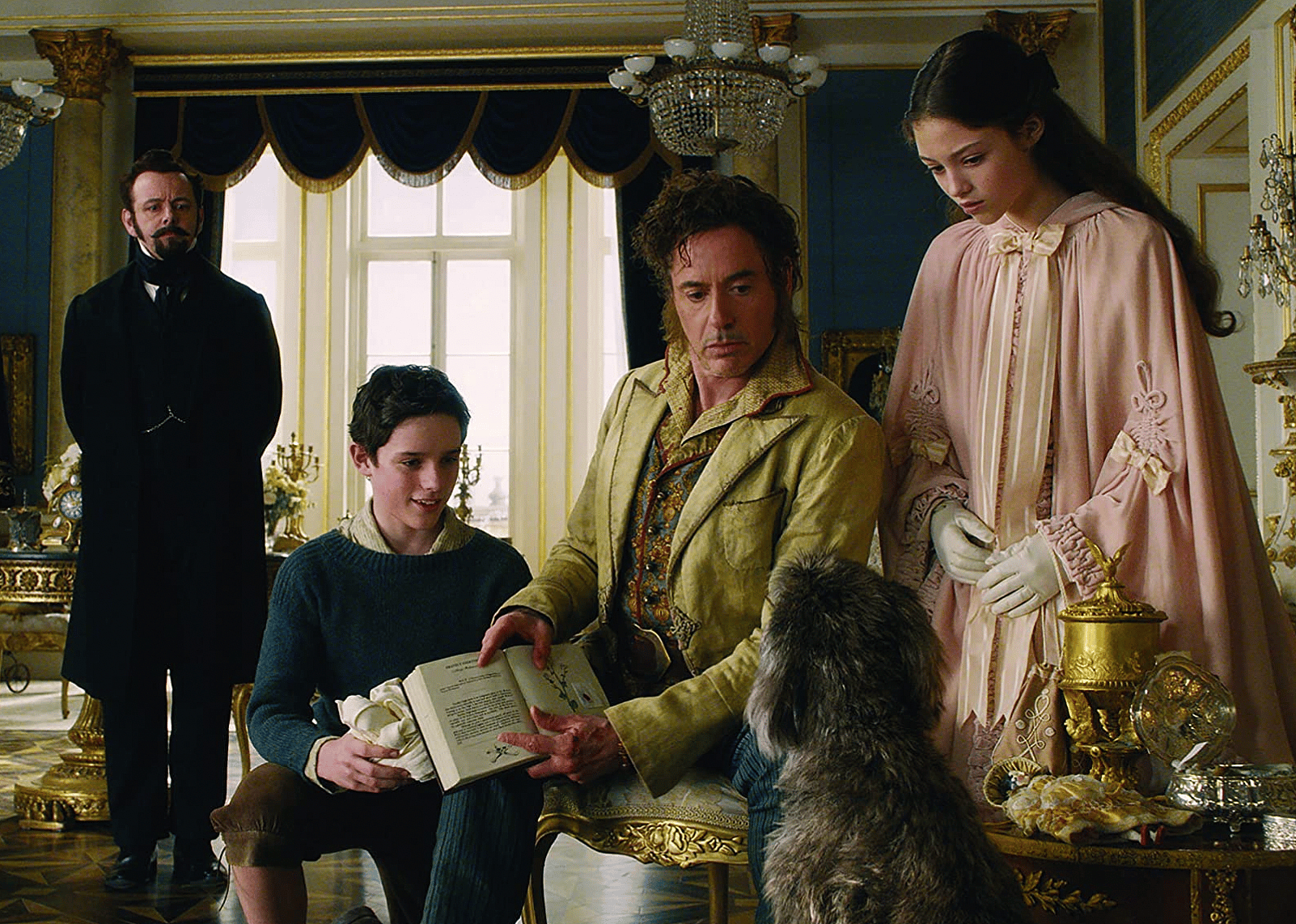 Robert Downey Jr., Jim Broadbent, Michael Sheen, Tom Holland, Harry Collett, and Carmel Laniado in "Dolittle".