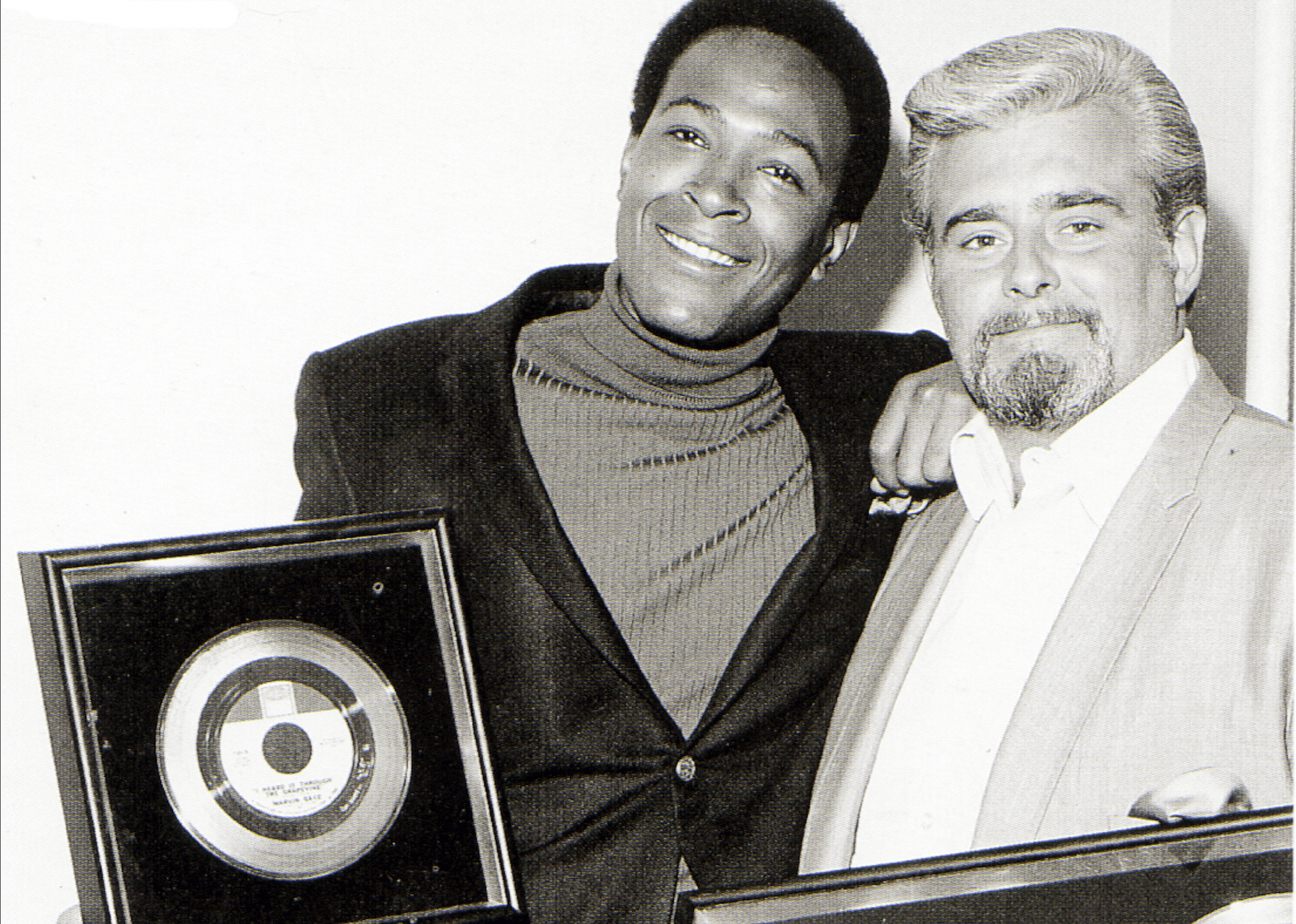 Marvin Gaye with Barney Ales of Motown with gold discs of single 'I Heard It Through The Grapevine'