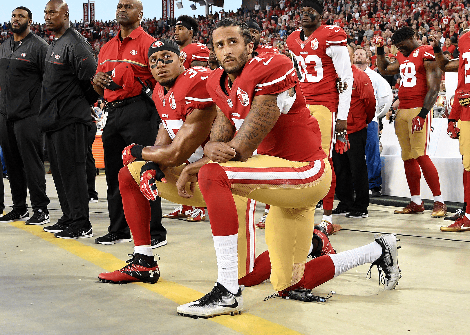 Colin Kaepernick kneeling at a game.