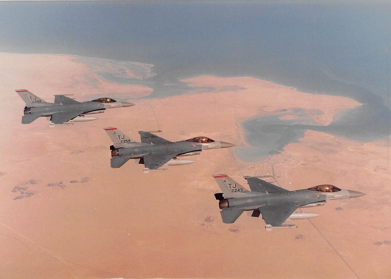 Pictured: Col. Bruce "Baghdad" Cox, 307th Bomb Wing commander, Barksdale Air Force Base, Louisiana, flies his F-16 Fighting Falcon in formation with two other jets in Southwest Asia during operations Desert Shield and Desert Storm