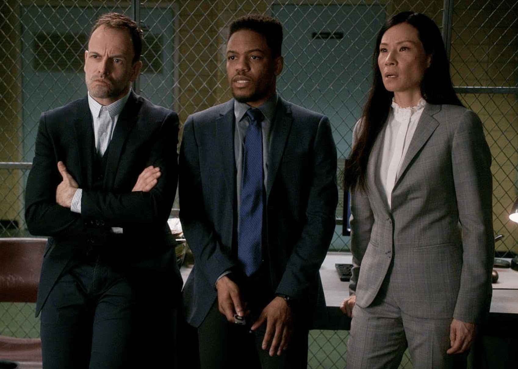 Jonny Lee Miller, Lucy Liu, and Jon Michael Hill in an episode of "Elementary"
