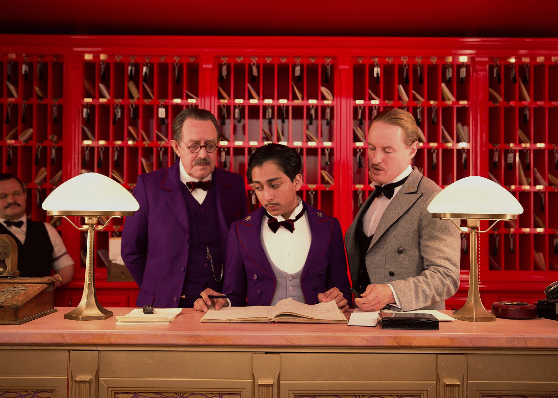 Owen Wilson, Larry Pine, and Tony Revolori in "The Grand Budapest Hotel."