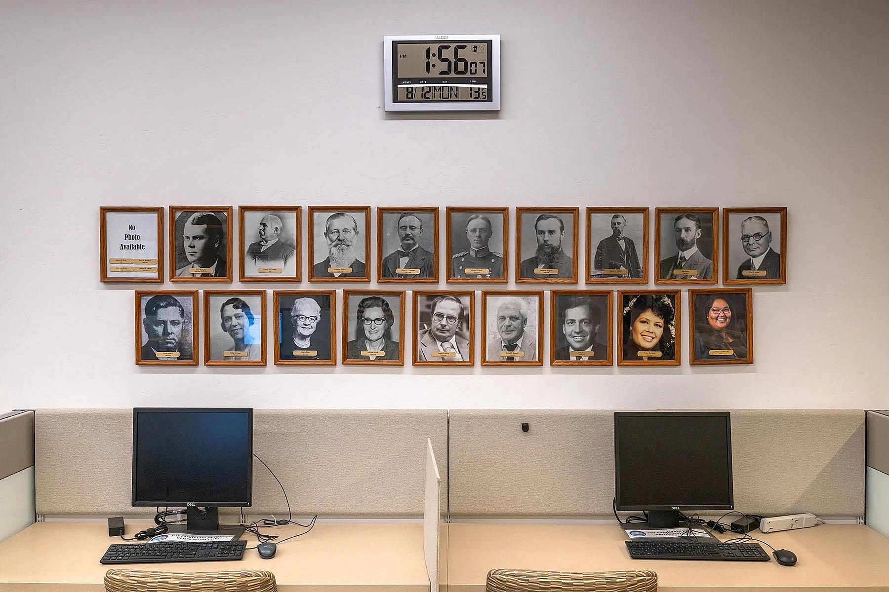 Displays of framed portraits of Pima County Recorders, including Cázares-Kelly, at her offices.