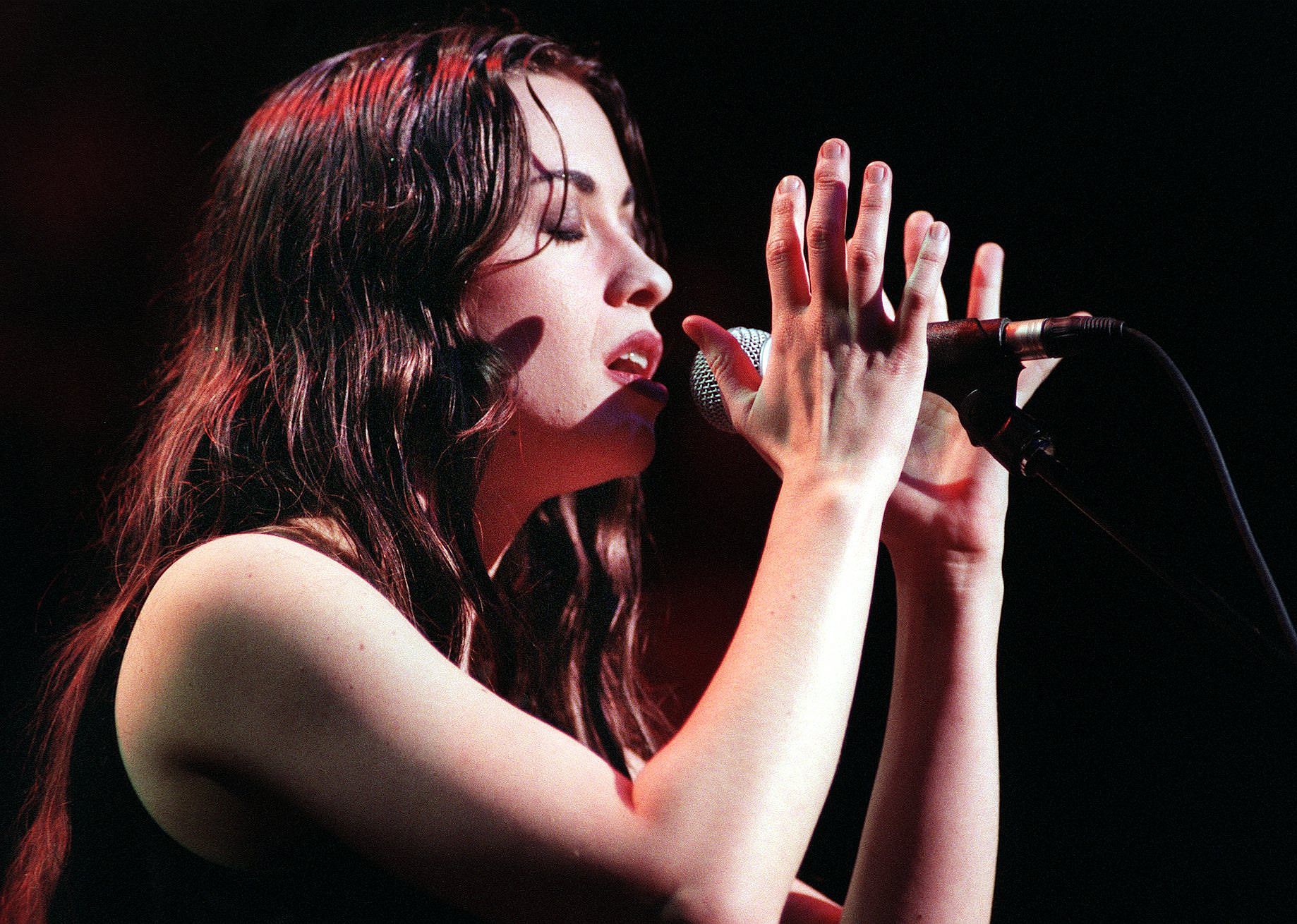 Alanis Morissette performing onstage.