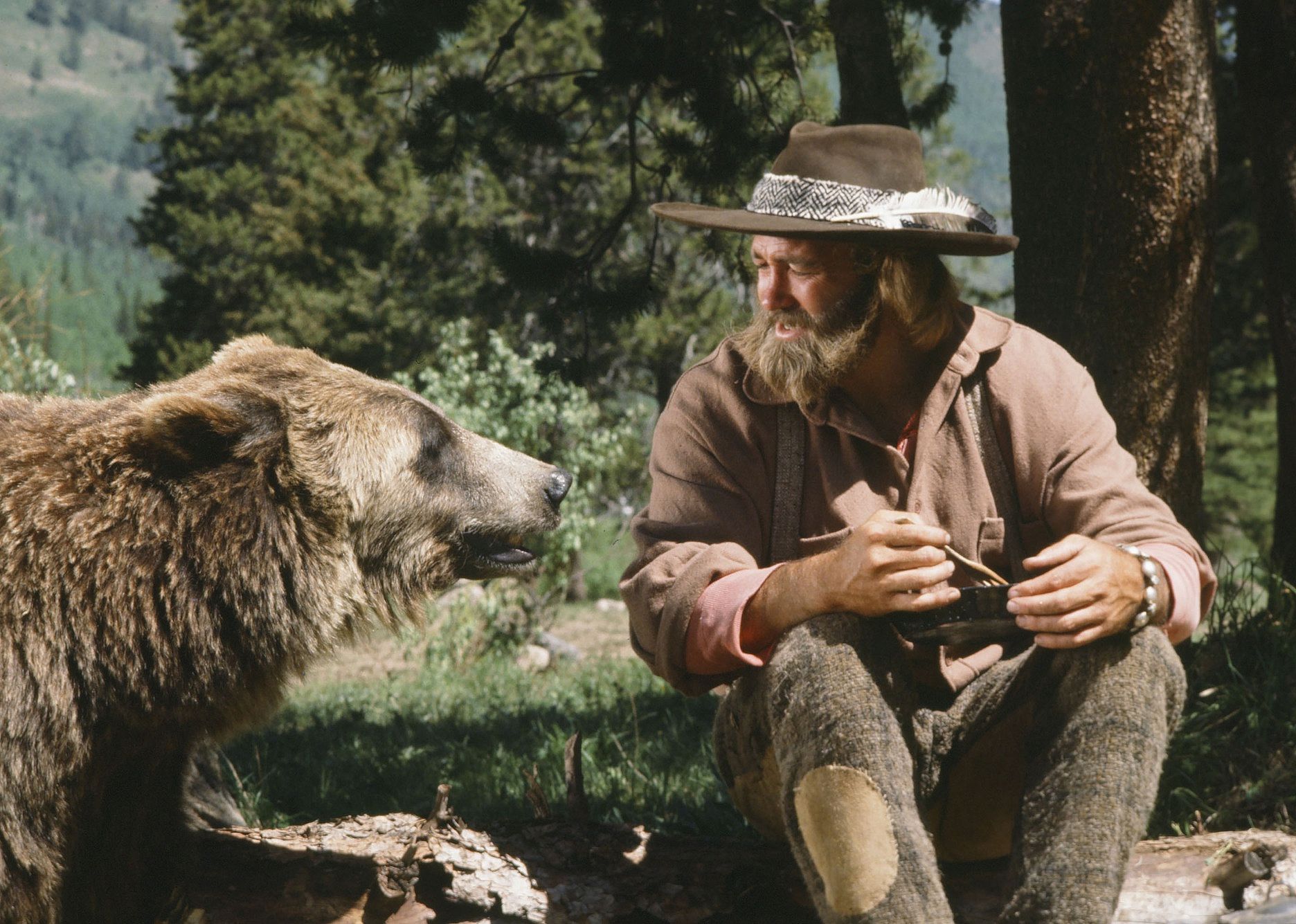 A man talking to a bear.
