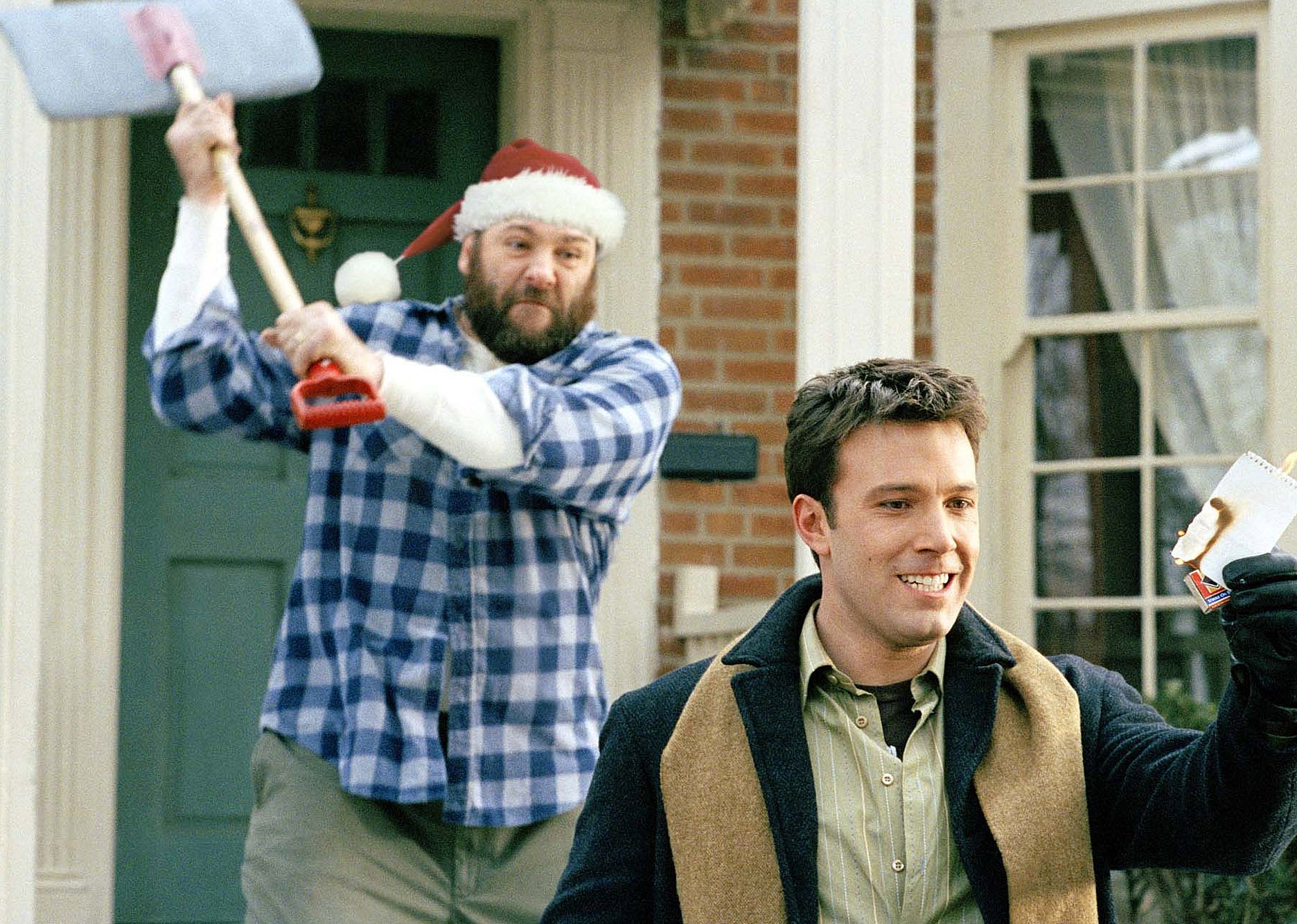 James Gandolfini aiming to hit Ben Affleck with a snow shovel.