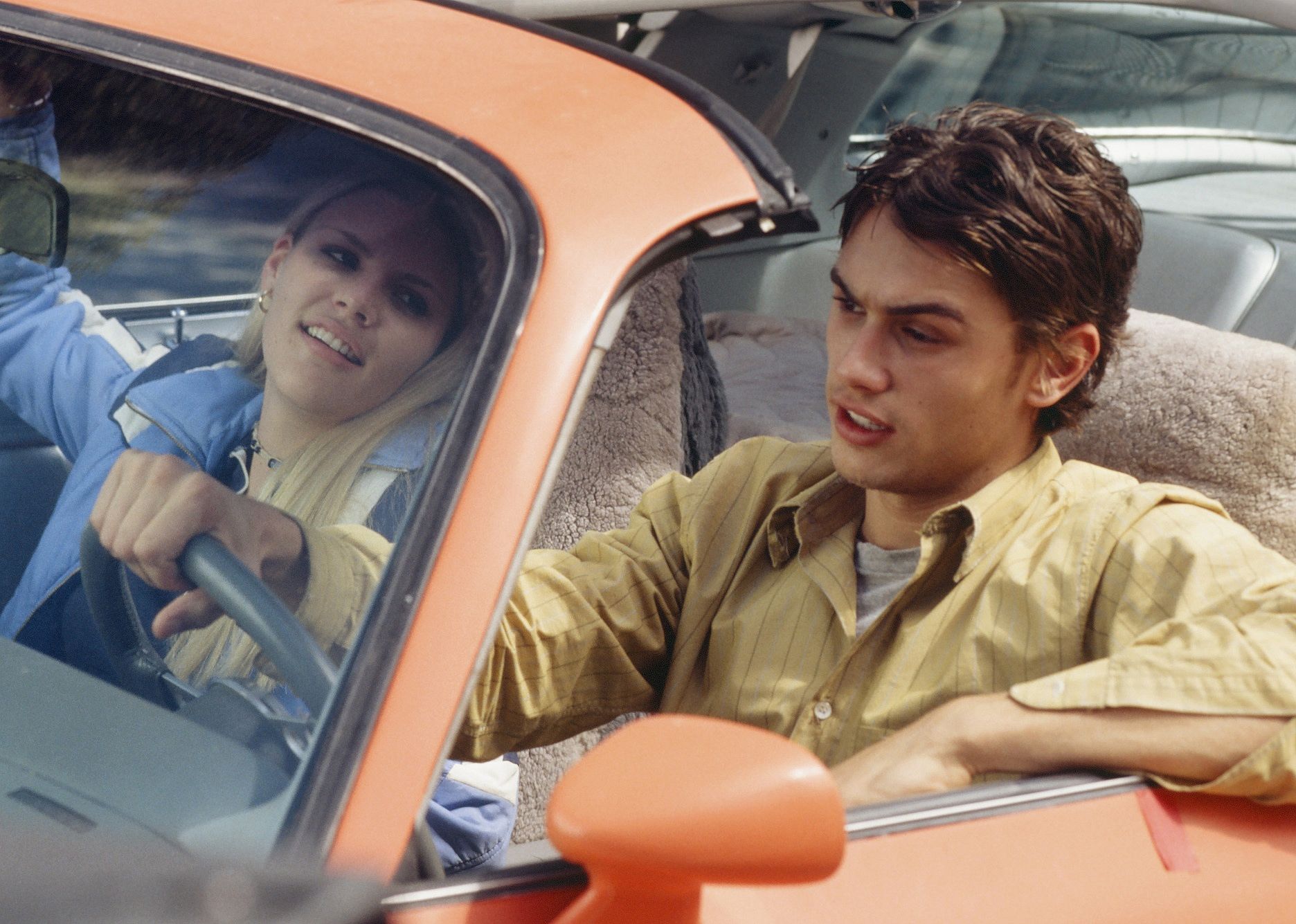 Busy Philipps and James Franco in a car in the show.