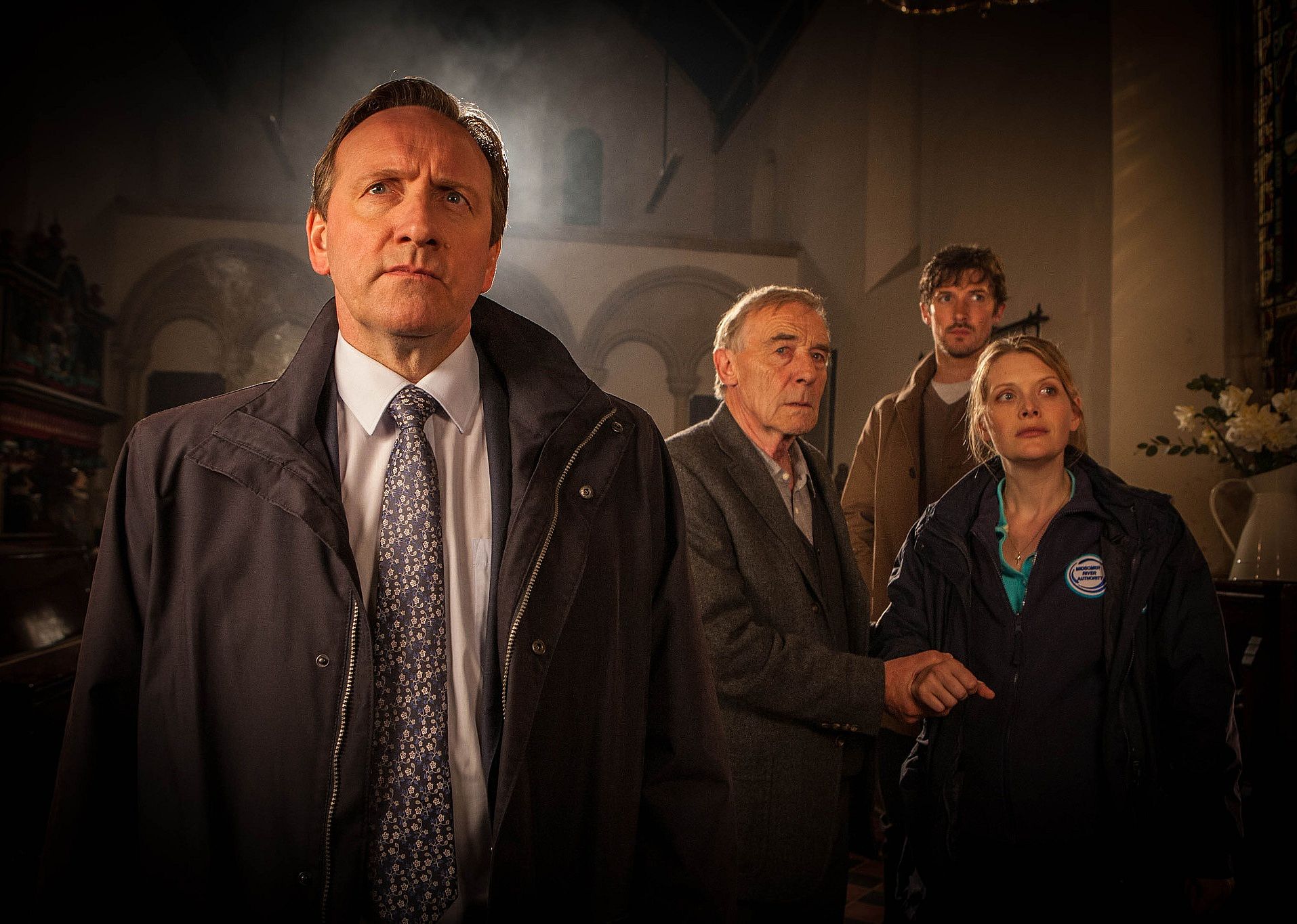 Detectives looking at something in the distance.