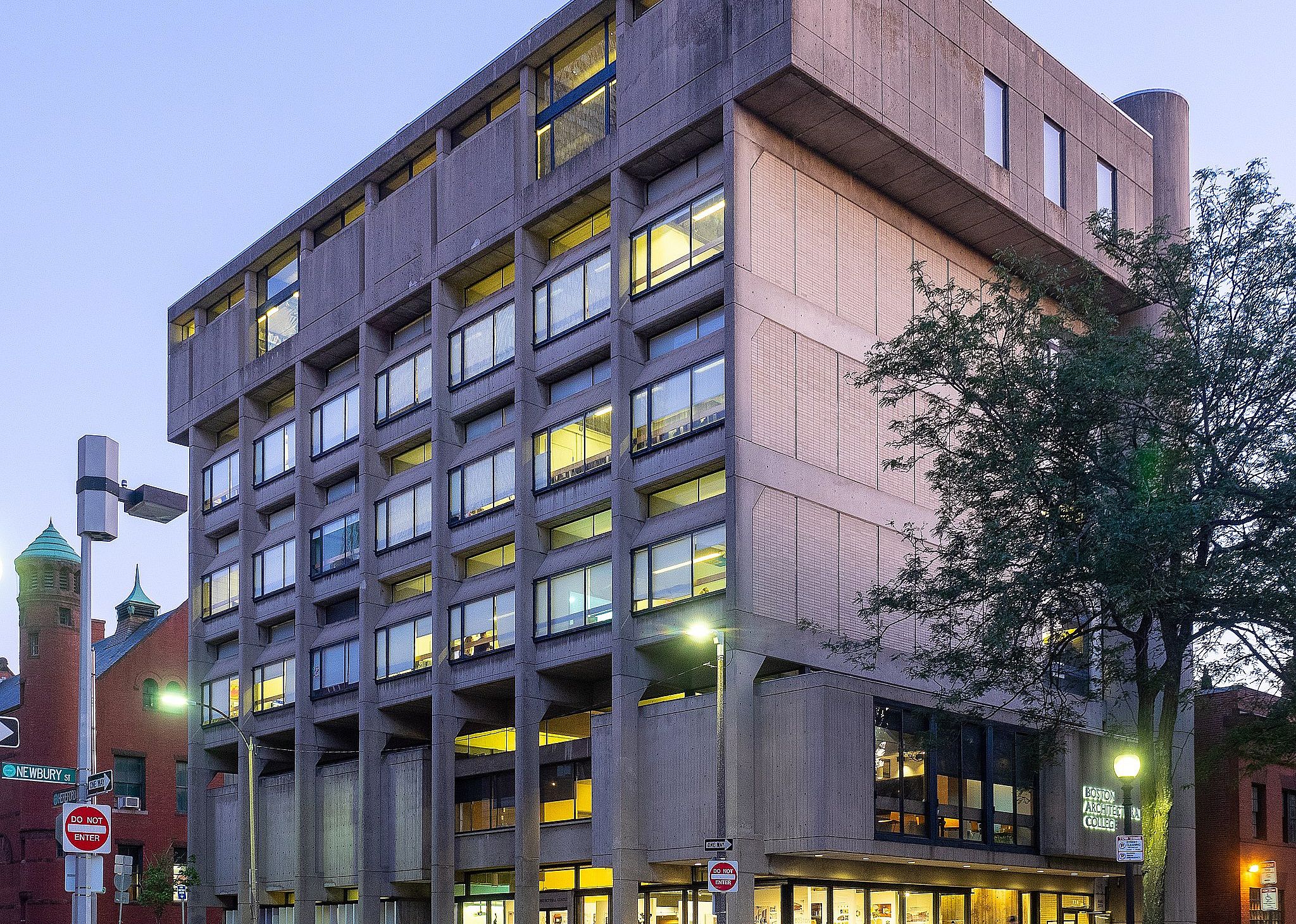 A tall concrete building at dusk.