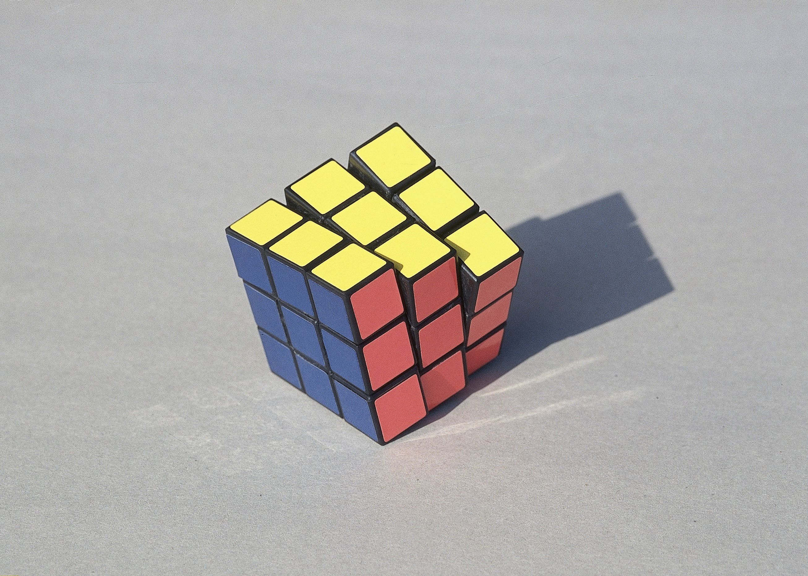 Close up on a Rubik’s Cube puzzle on a white background.