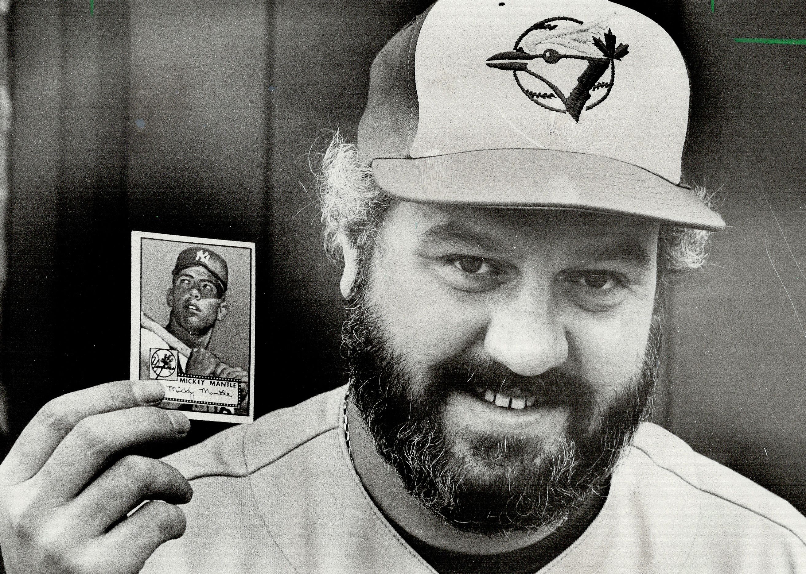 Dave Crichton holds a 1952 Mickey Mantle baseball card