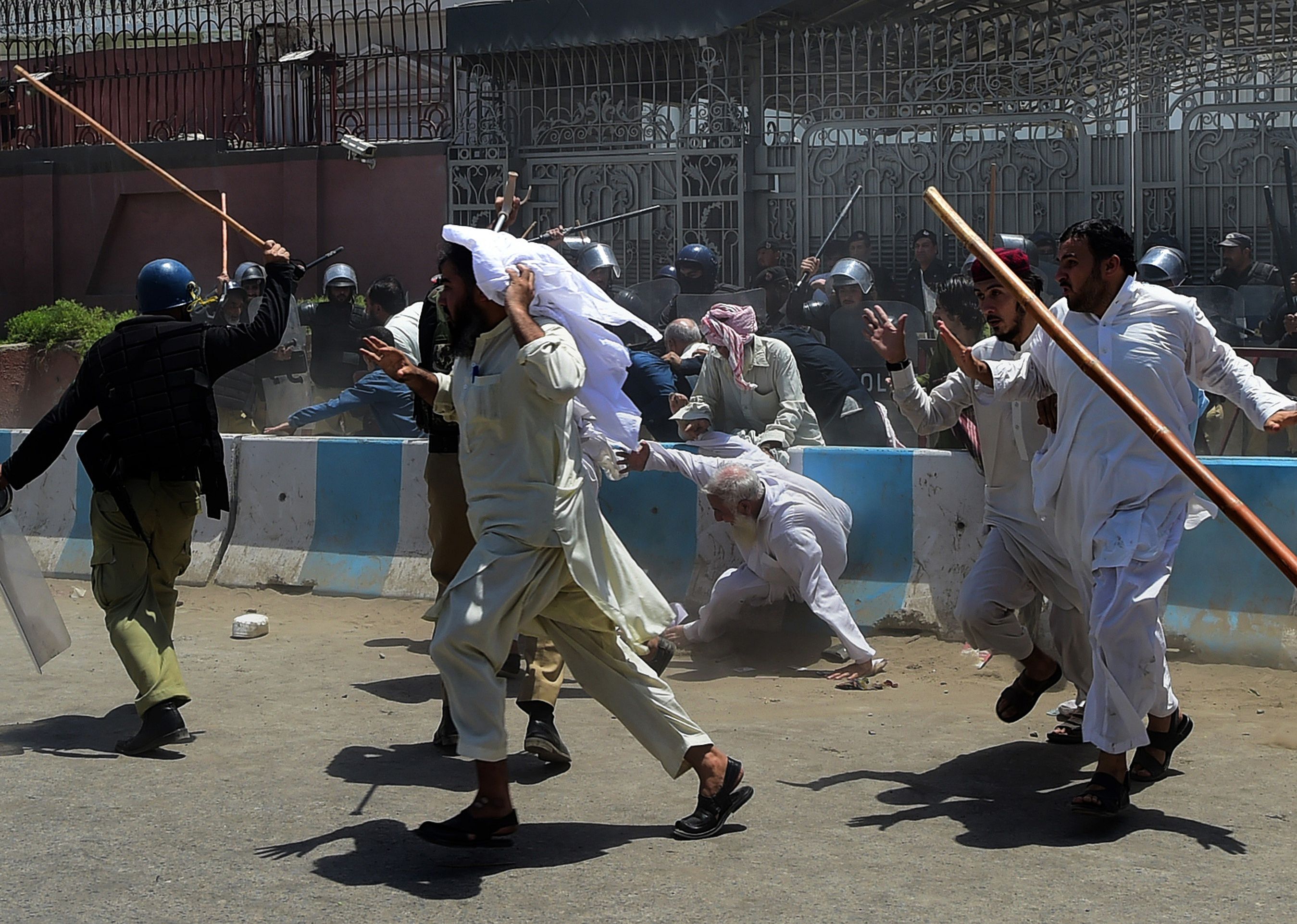 Activists run from policemen during a protest