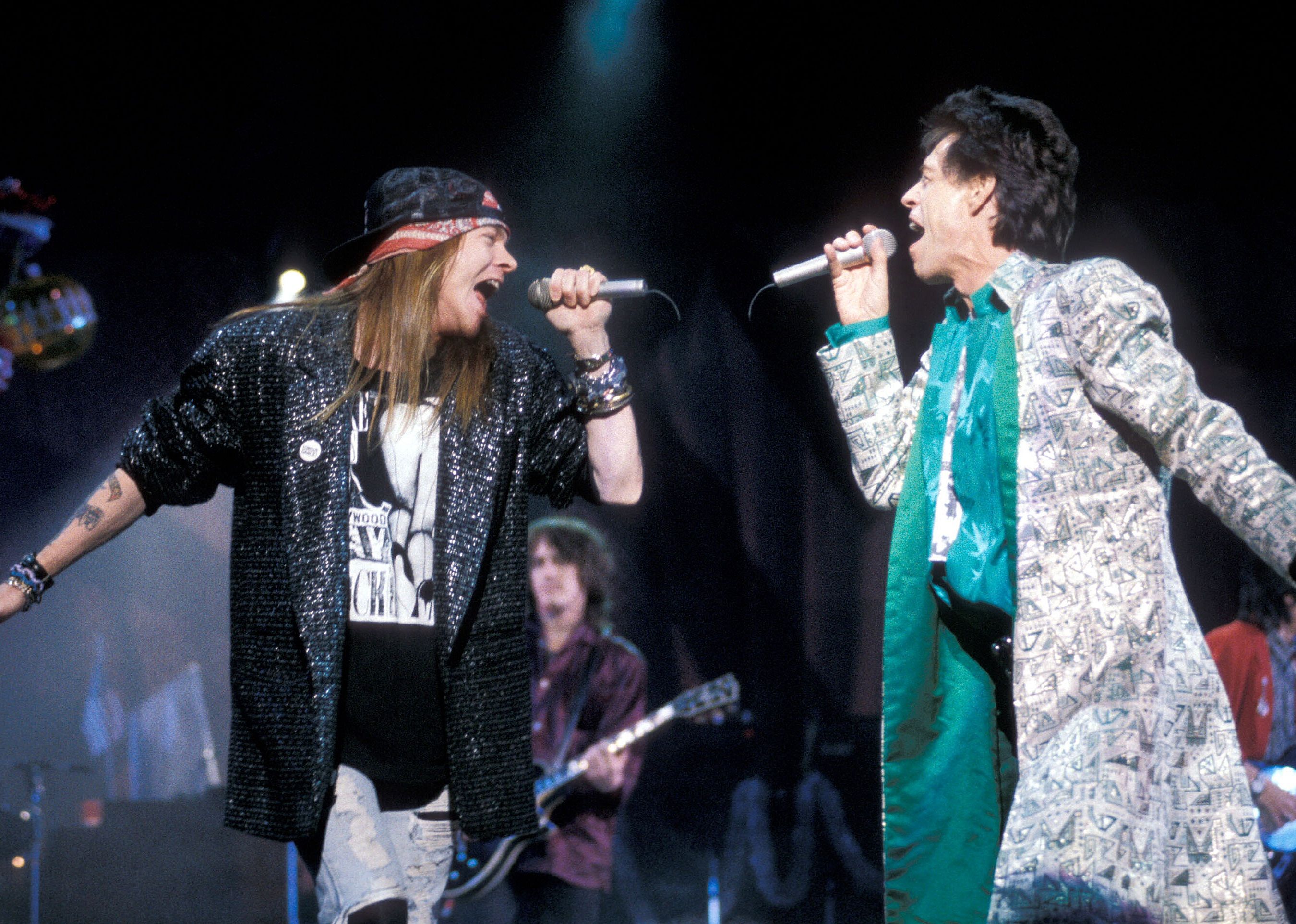 Axl Rose of Guns N' Roses and Mick Jagger of the Rolling Stones performing.