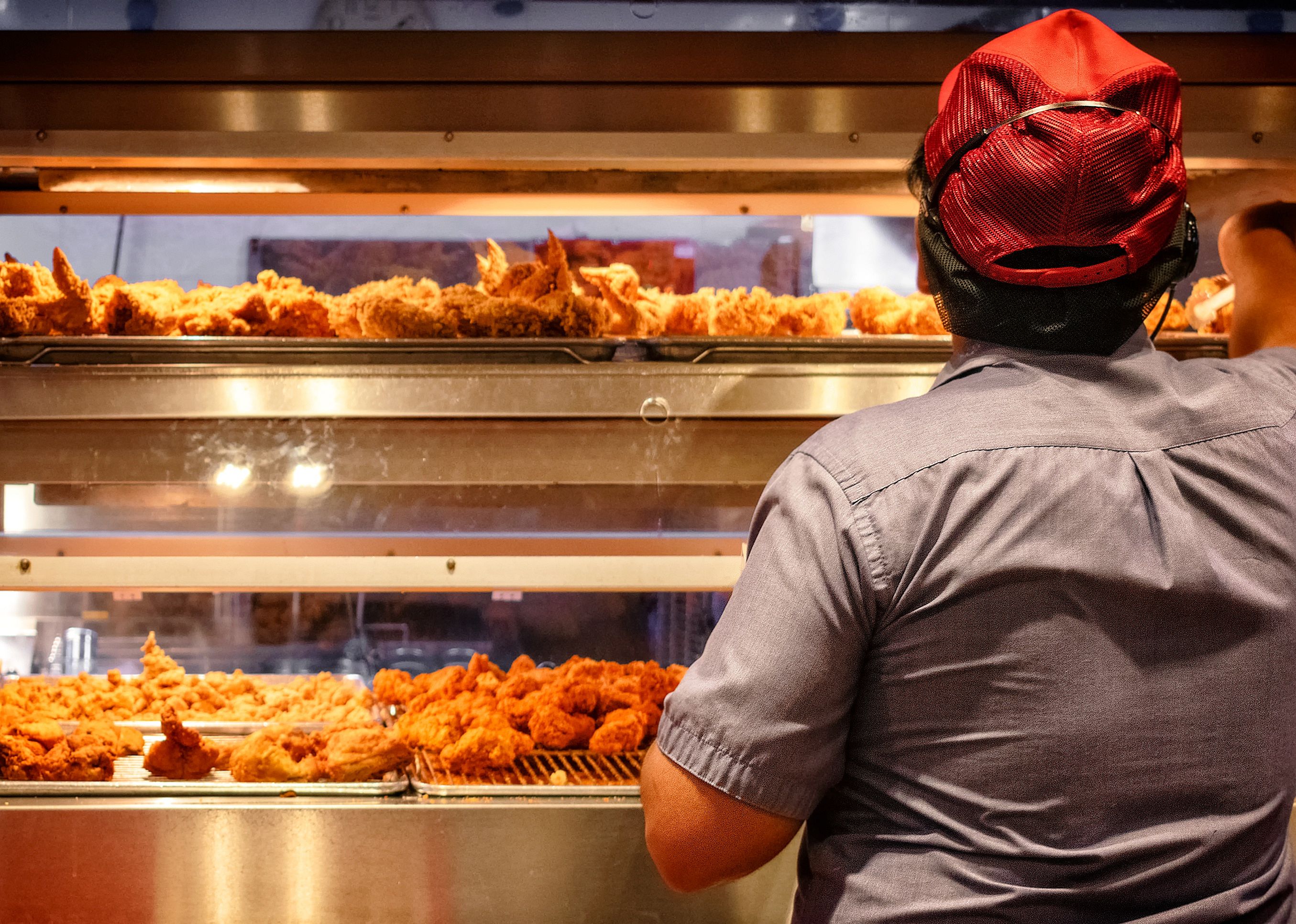 Employee works in a fast food kitchen.