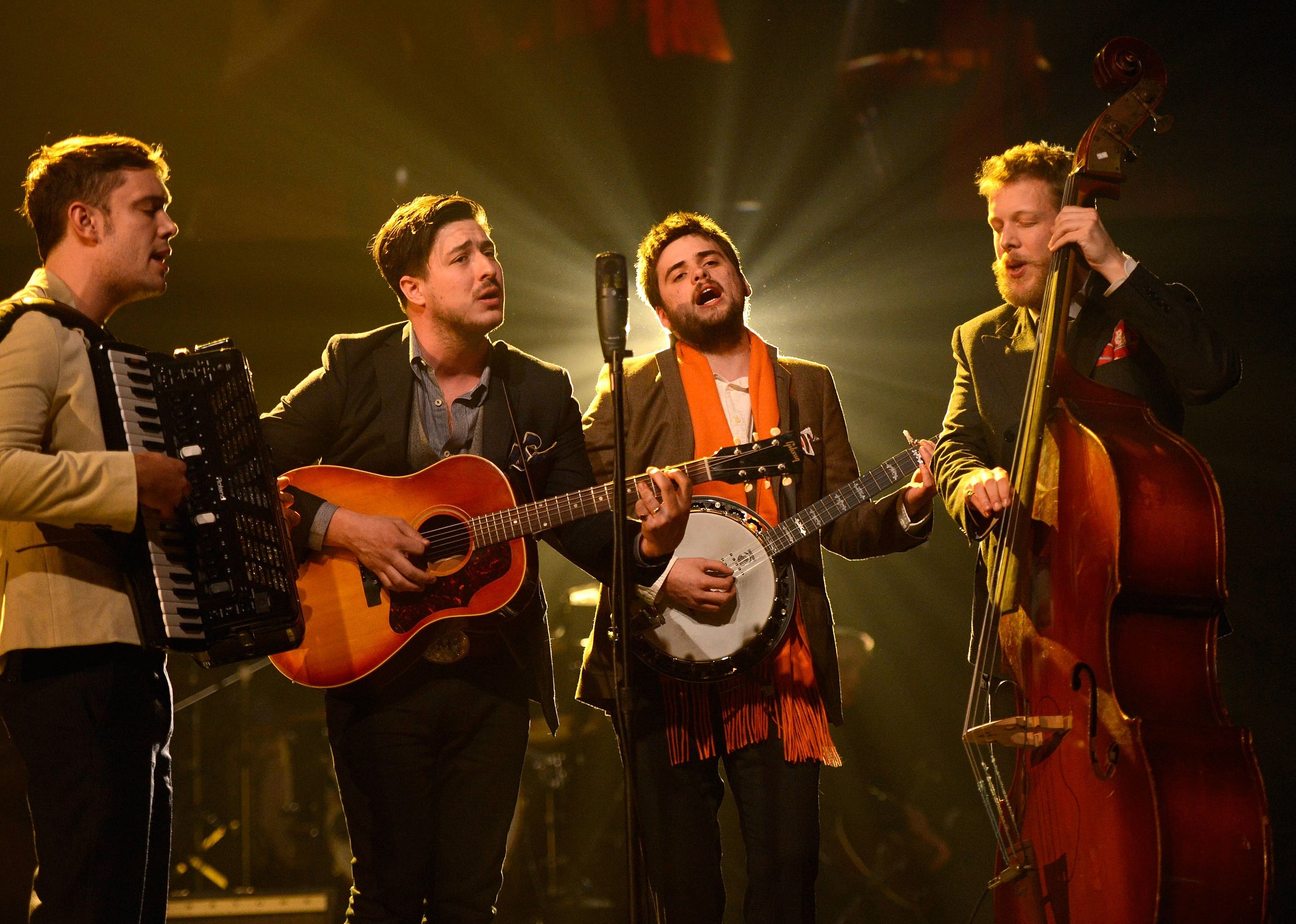 Mumford & Sons performing onstage.