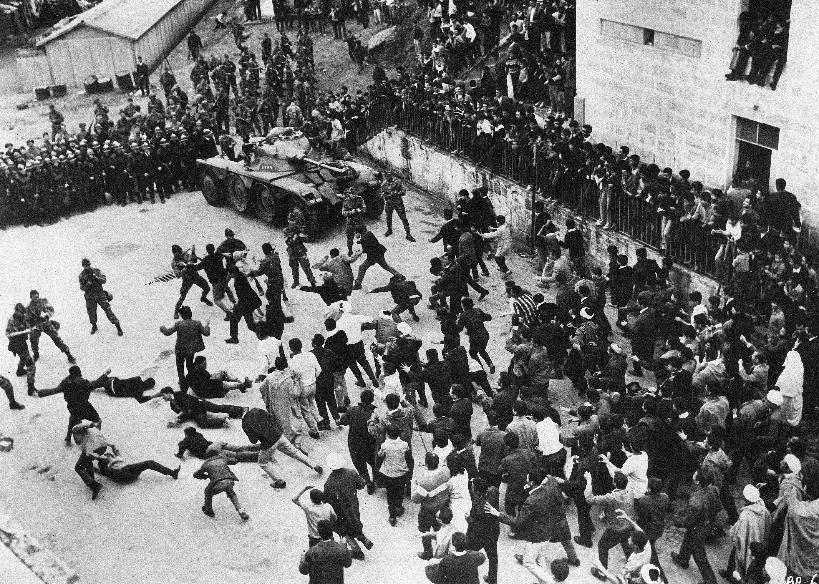 A courtyard full of people and a tank fighting.