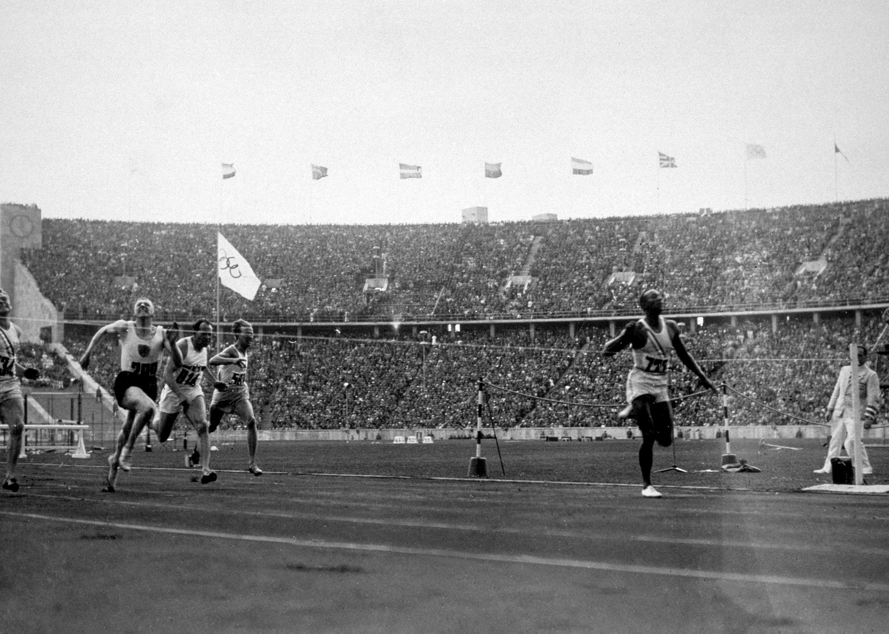 1936: Jesse Owens wins 100-meter gold at Berlin Olympics