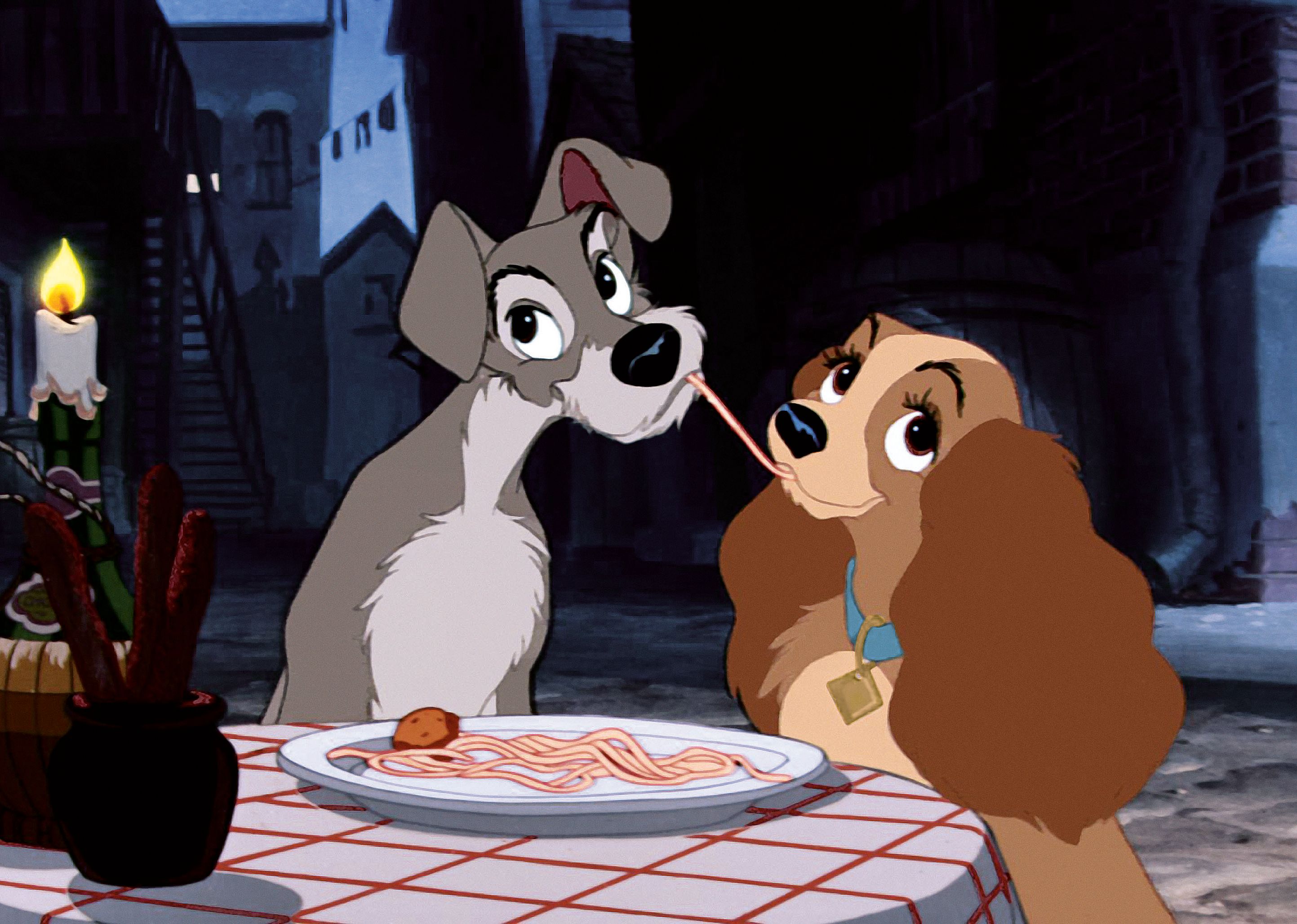 A cartoon of Lady and the Tramp sharing a plate of pasta at a candlelit dinner.