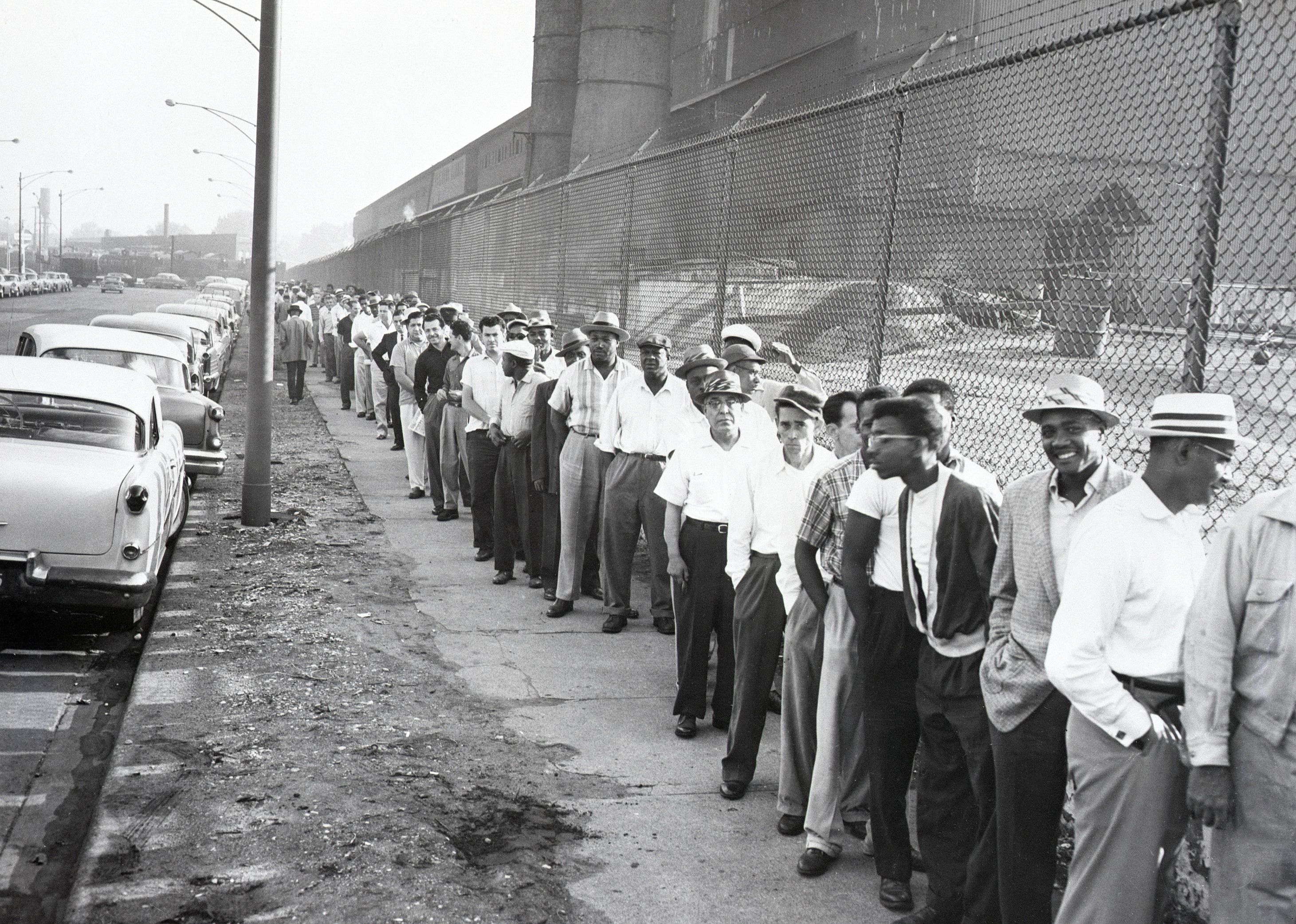 A long line of striking steelworkers queue up to receive pay checks