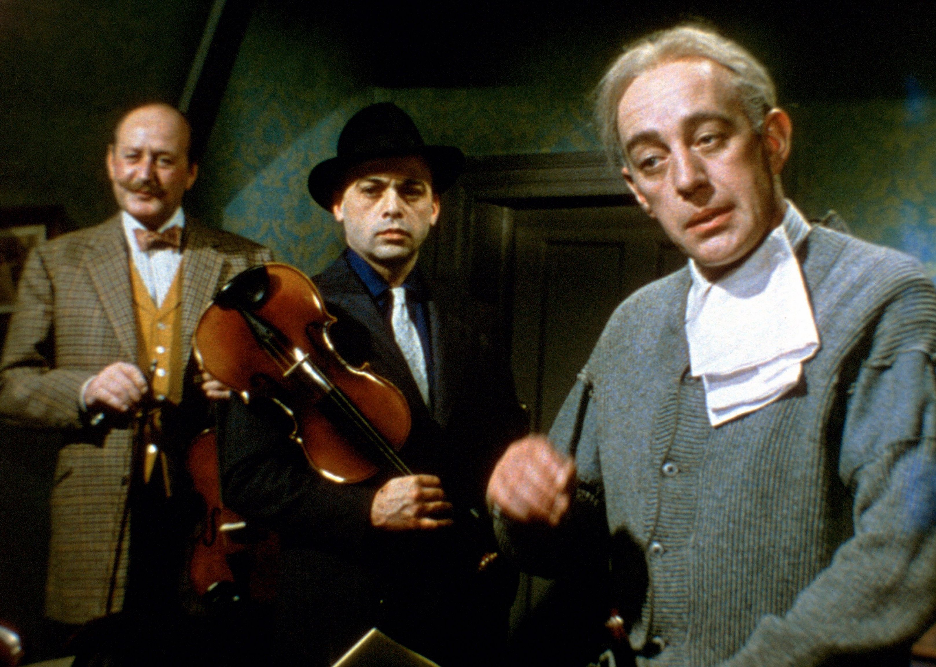 3 men with musical instruments in a house.