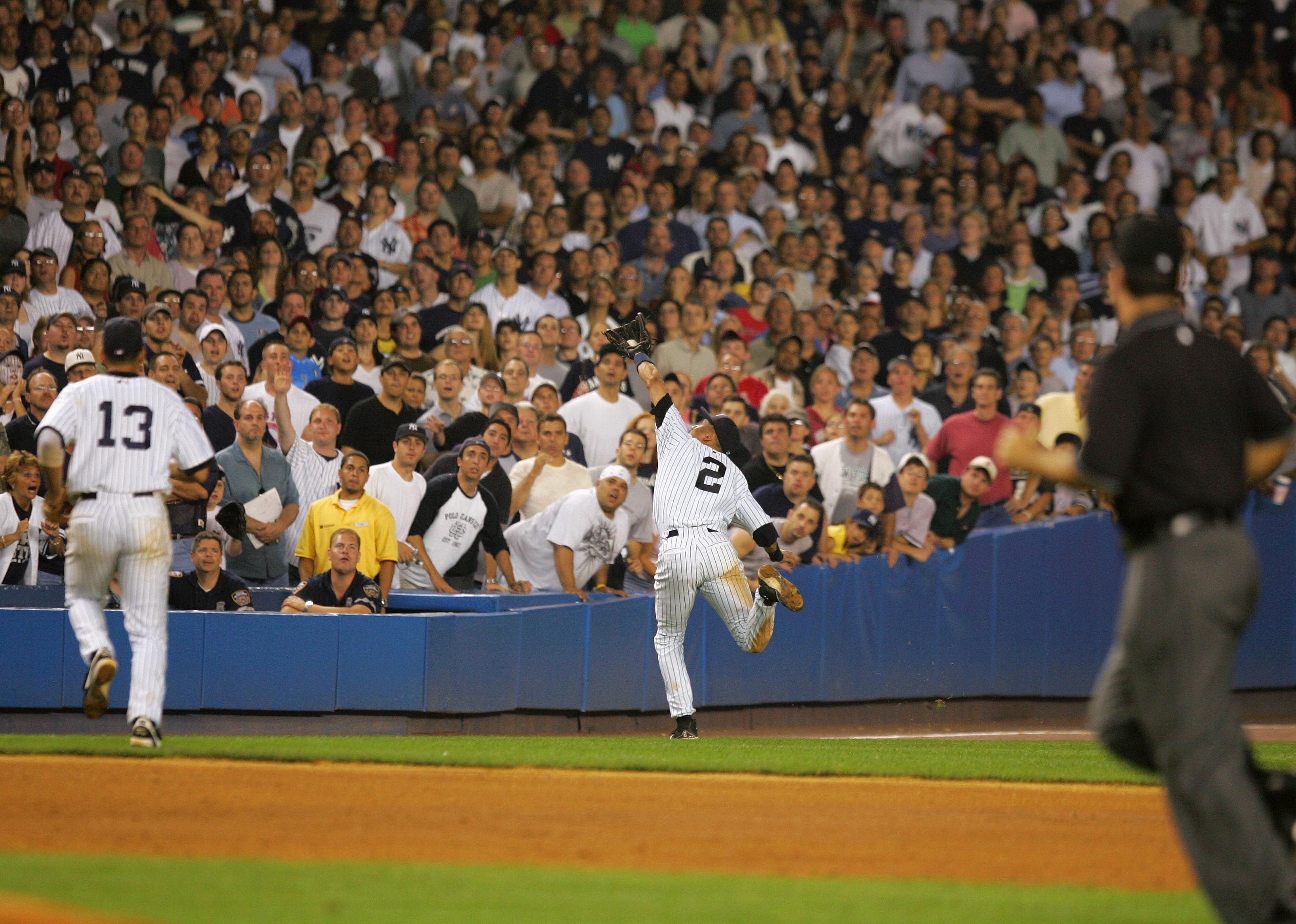 2004: Derek Jeter makes diving catch vs. Red Sox, crashes into stands