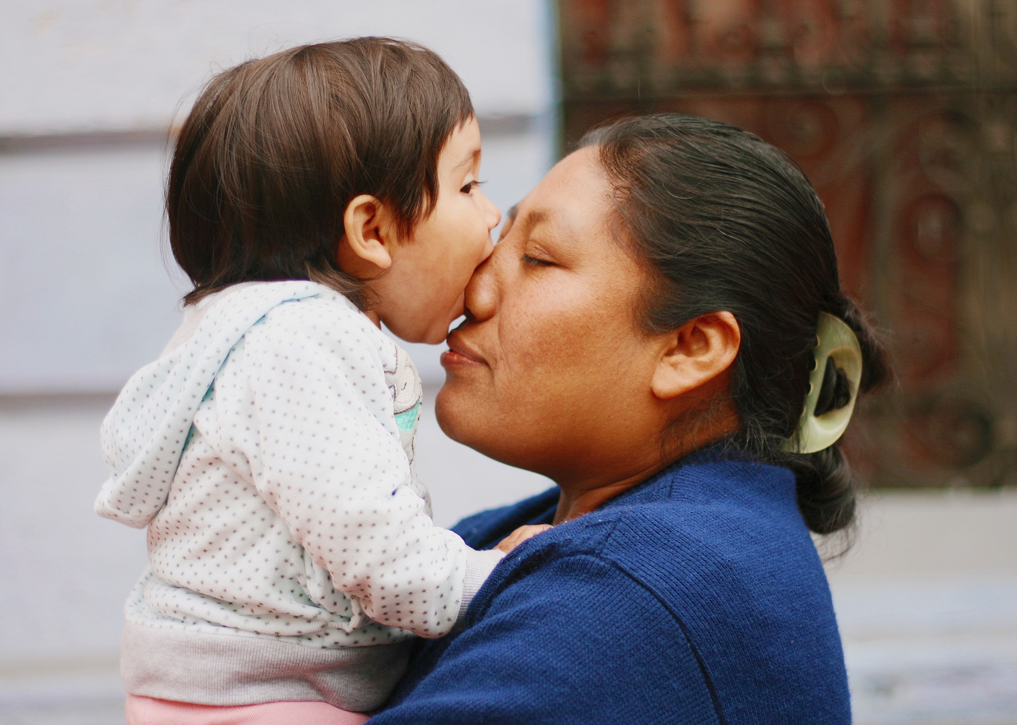 Side view of woman playing with daughter