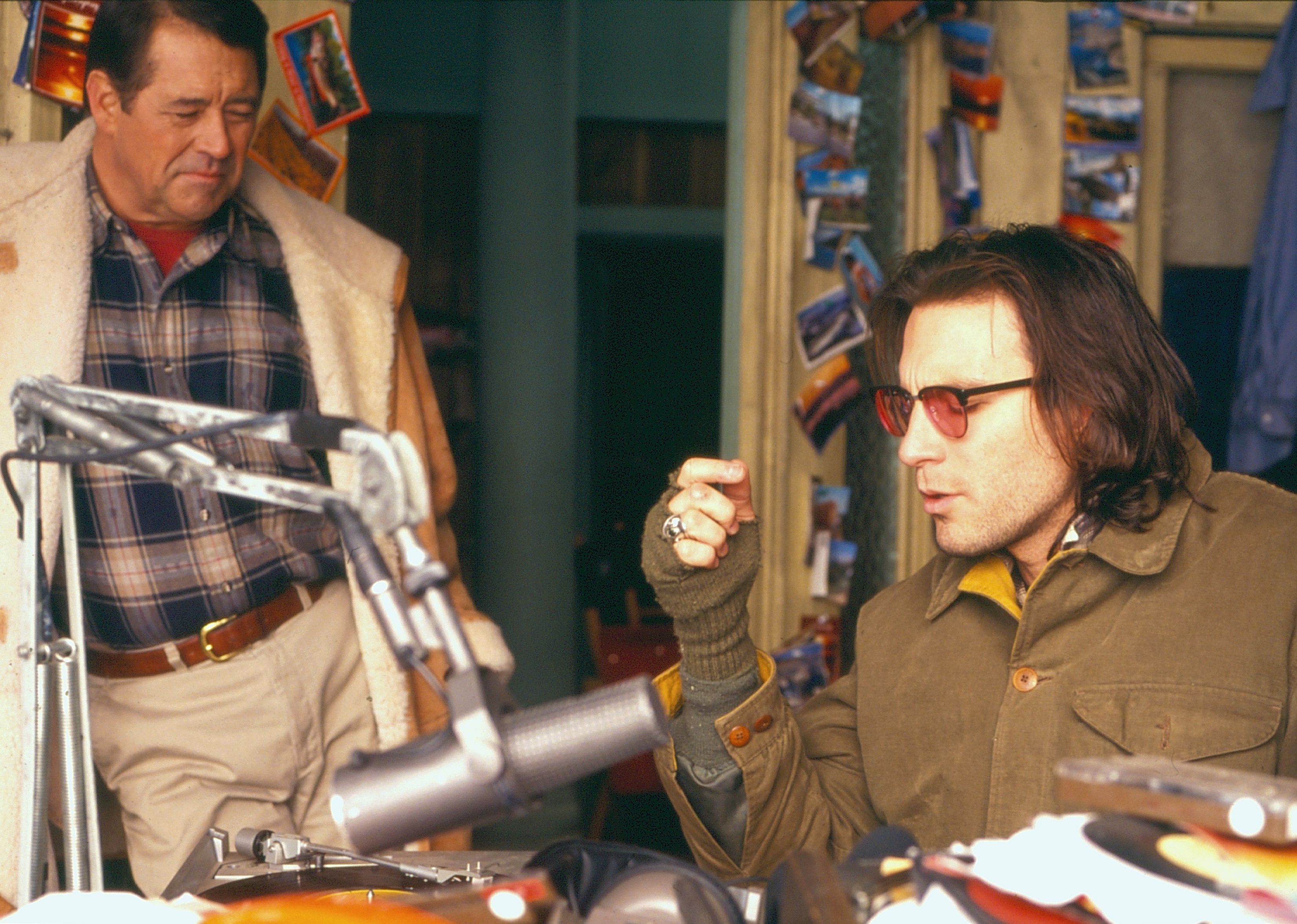 John Corbett talking to an older man in a studio.