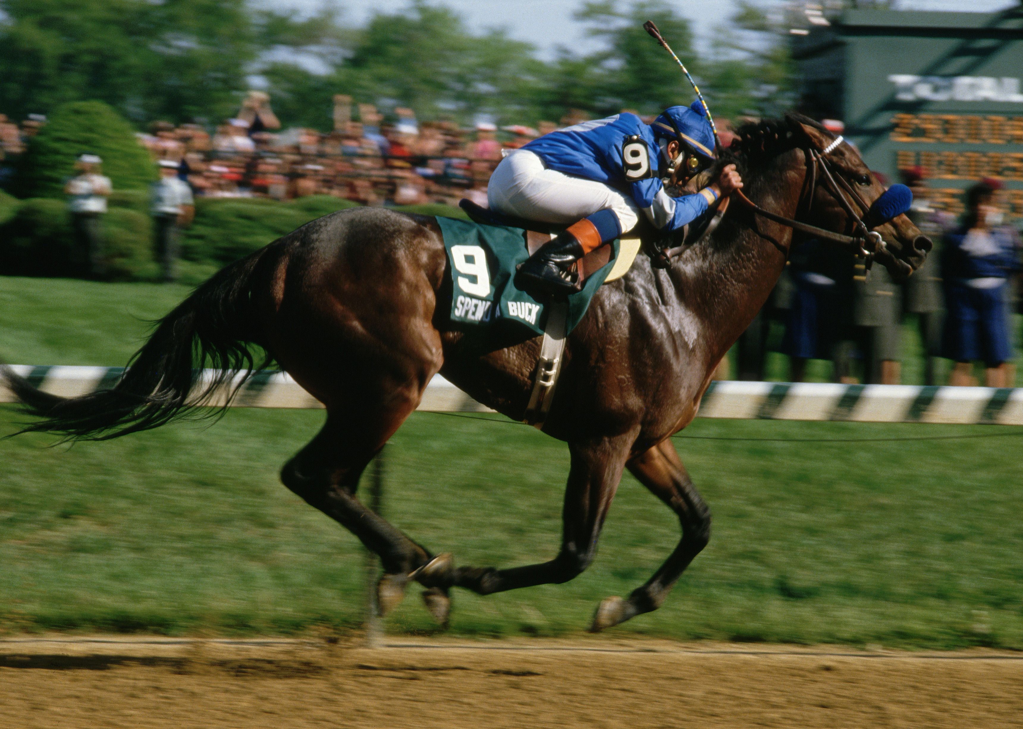 Angel Cordero Jr. rides his horse towards a finish line